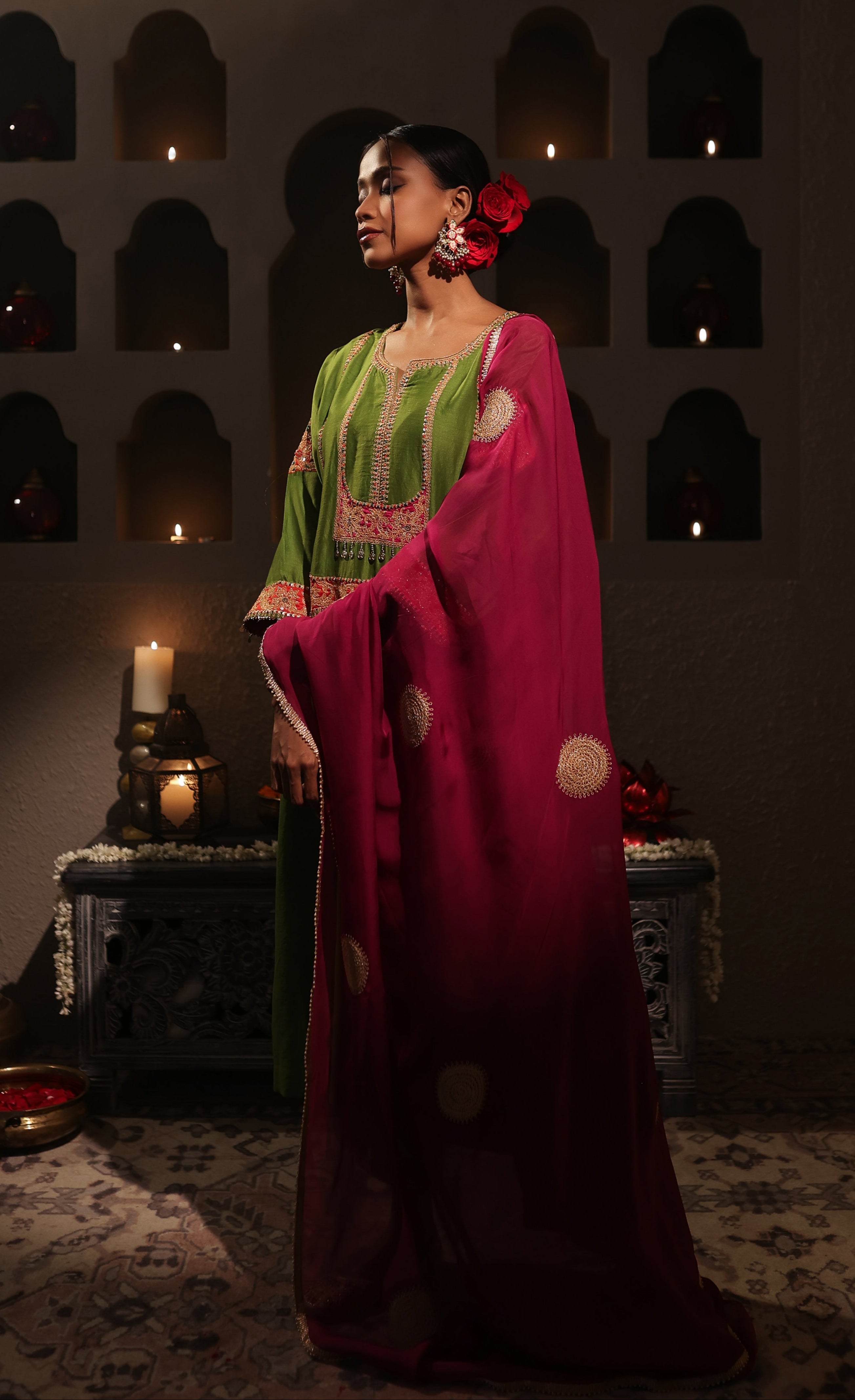 Model wearing a green silk chanderi kurta set with pink dupatta, featuring gold zari aari taari hand embroidery — festive ethnic outfit.