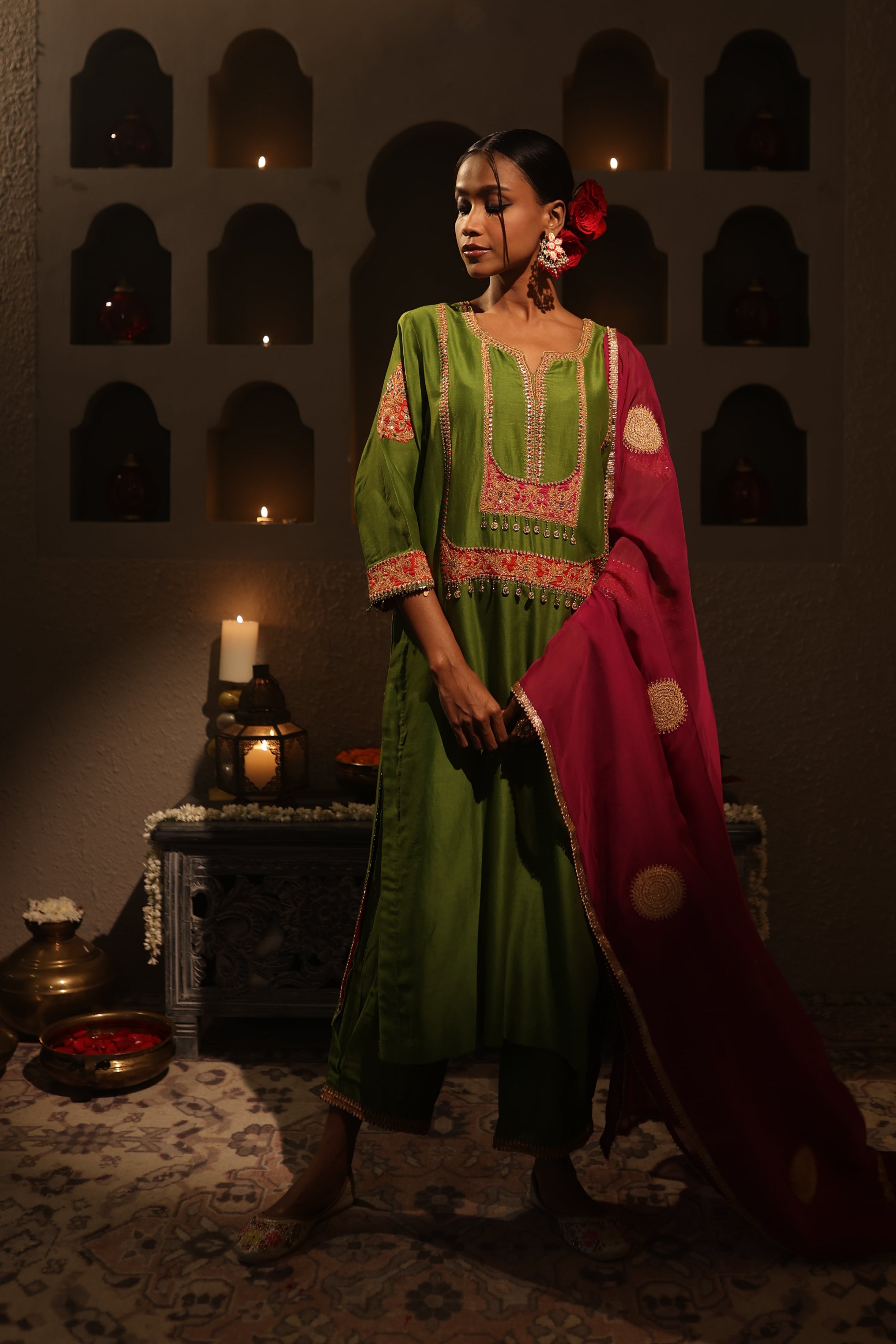 Model wearing a green silk chanderi kurta set with pink dupatta, featuring gold zari aari taari hand embroidery — festive ethnic outfit.