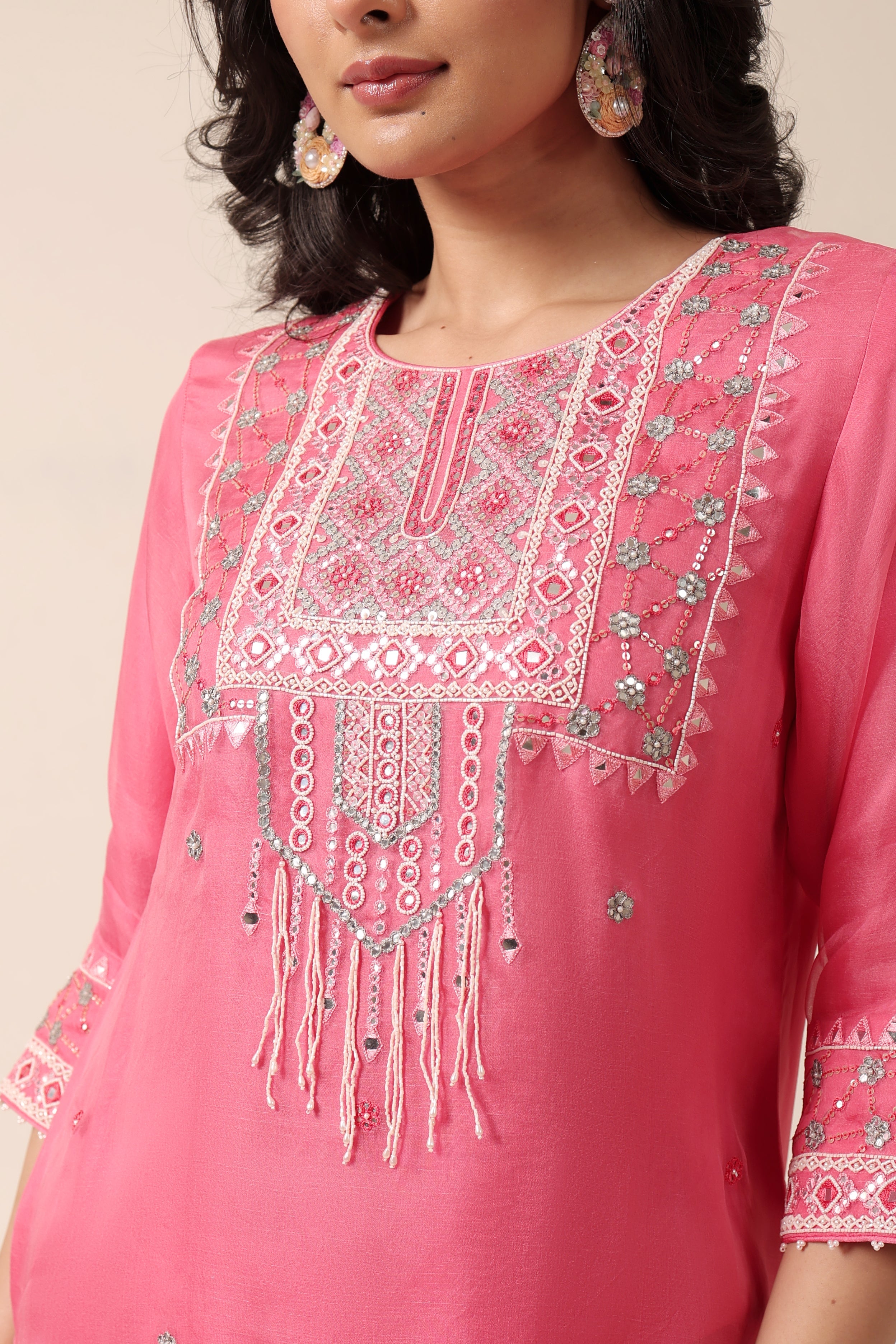 Model wearing pink tissue kurta with intricate mirror embroidery, styled with regal farshi salwar and dupatta – Jhilmil Collection by House of AAS.