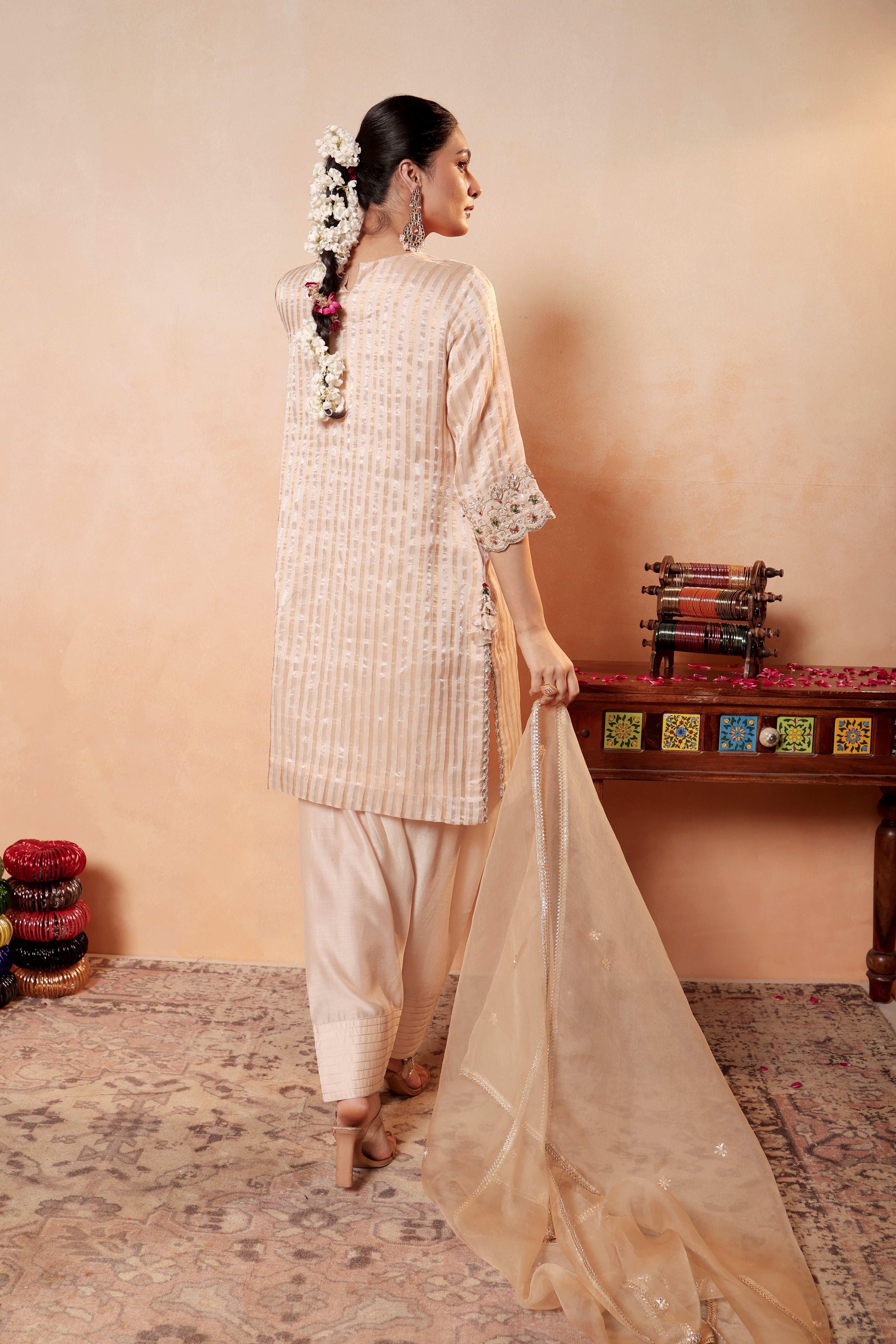 Model wearing beige Tissue Silk Chanderi kurta set from Sunehri Gota Collection with hand embroidery, farshi salwar, and dupatta – festive and wedding wear.