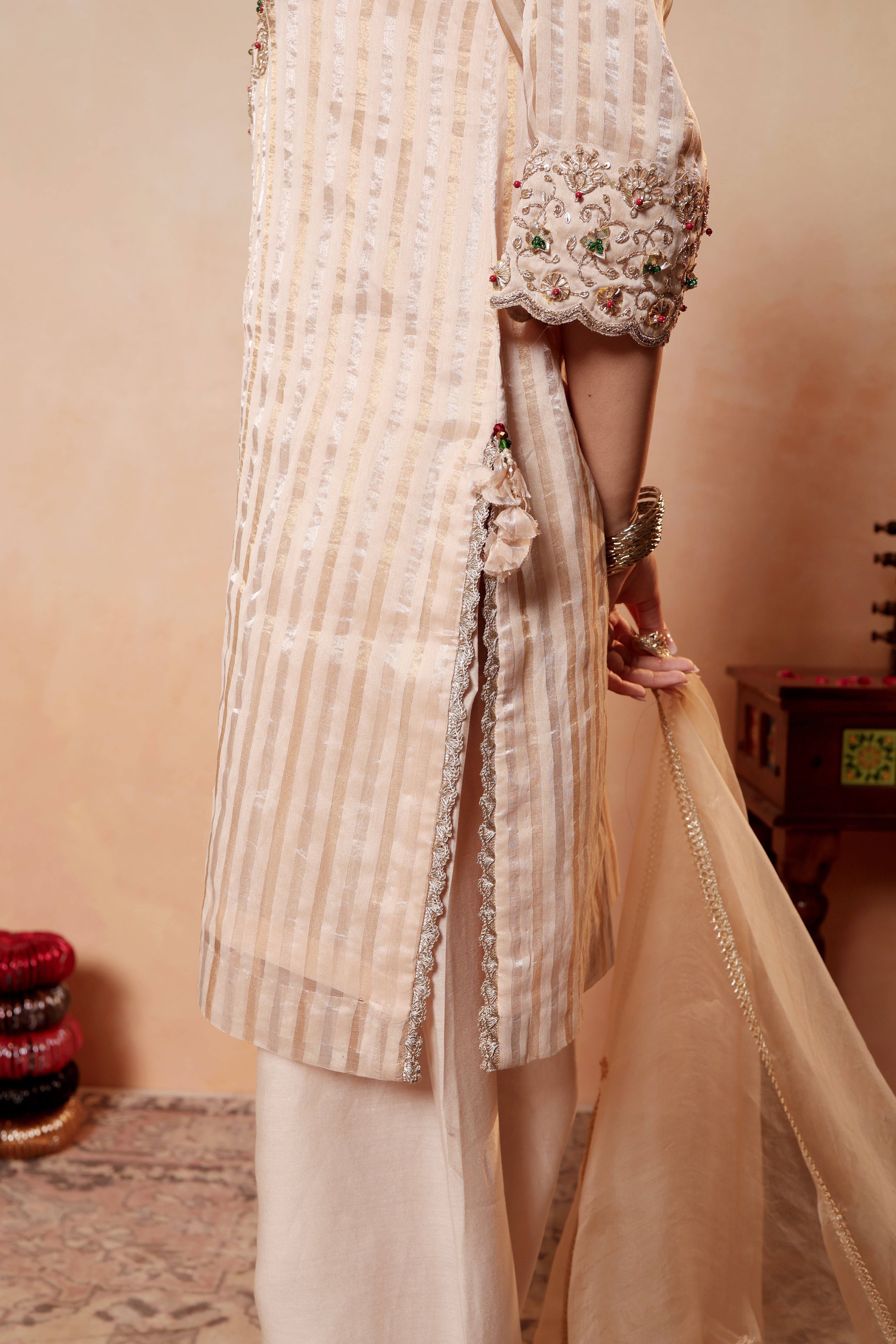 Model wearing beige Tissue Silk Chanderi kurta set from Sunehri Gota Collection with hand embroidery, farshi salwar, and dupatta – festive and wedding wear.
