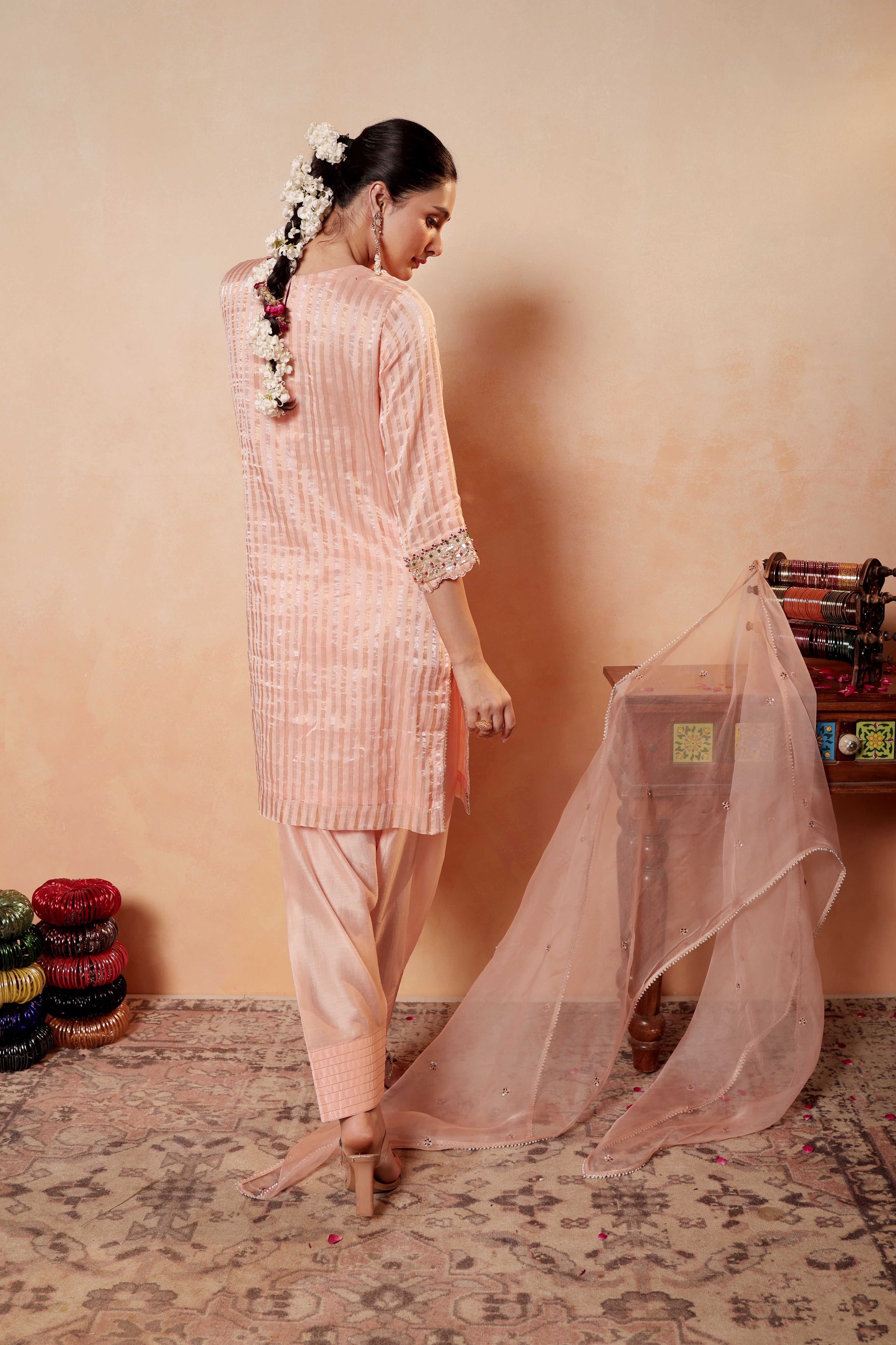 Model wearing peach Tissue Silk Chanderi kurta with gota embroidery, paired with regal farshi salwar and dupatta – Sunehri Gota Collection by House of AAS.