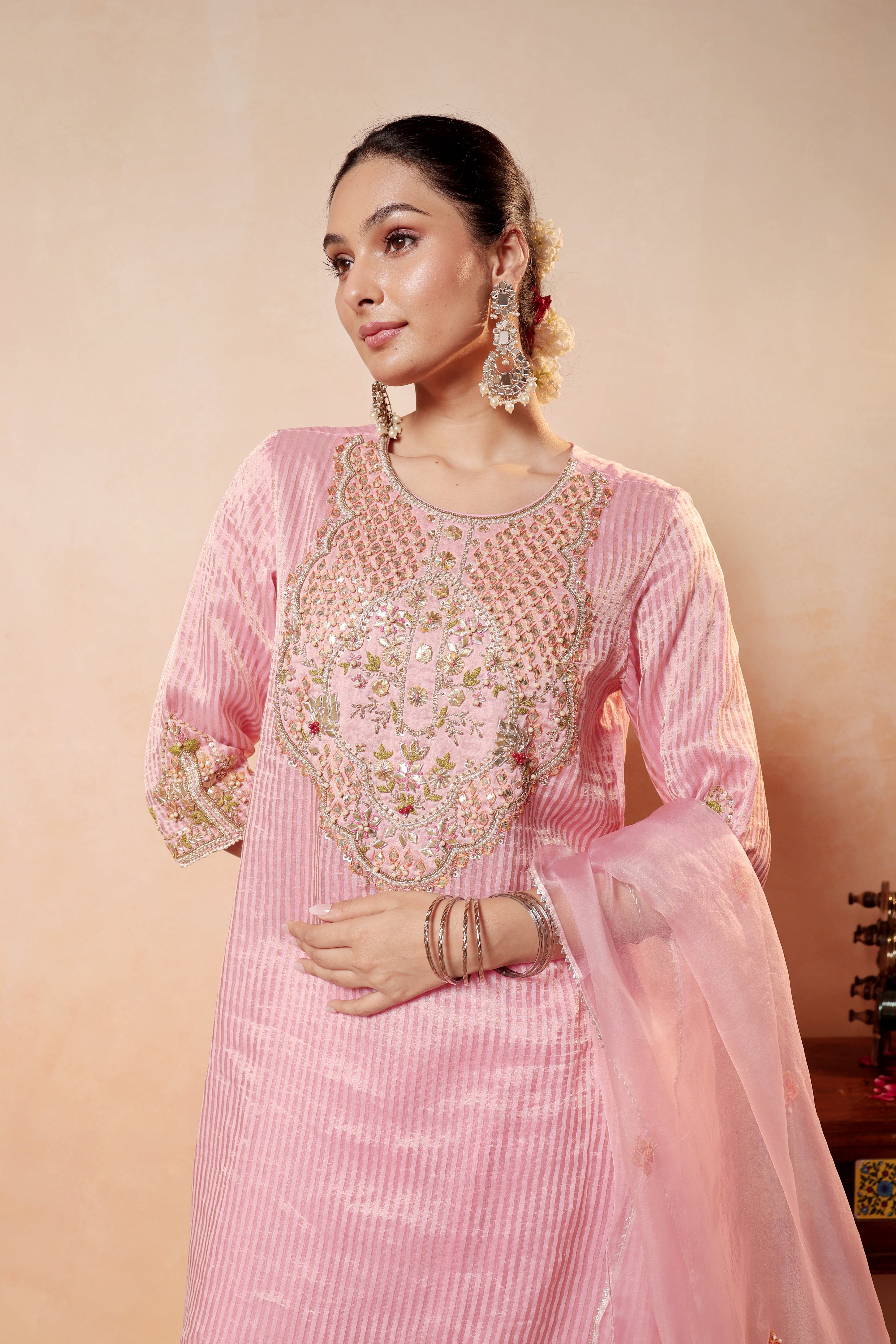 Model wearing pink tissue silk kurta with intricate gota embroidery, paired with regal farshi salwar and dupatta – Sunehri Gota Collection by House of AAS.