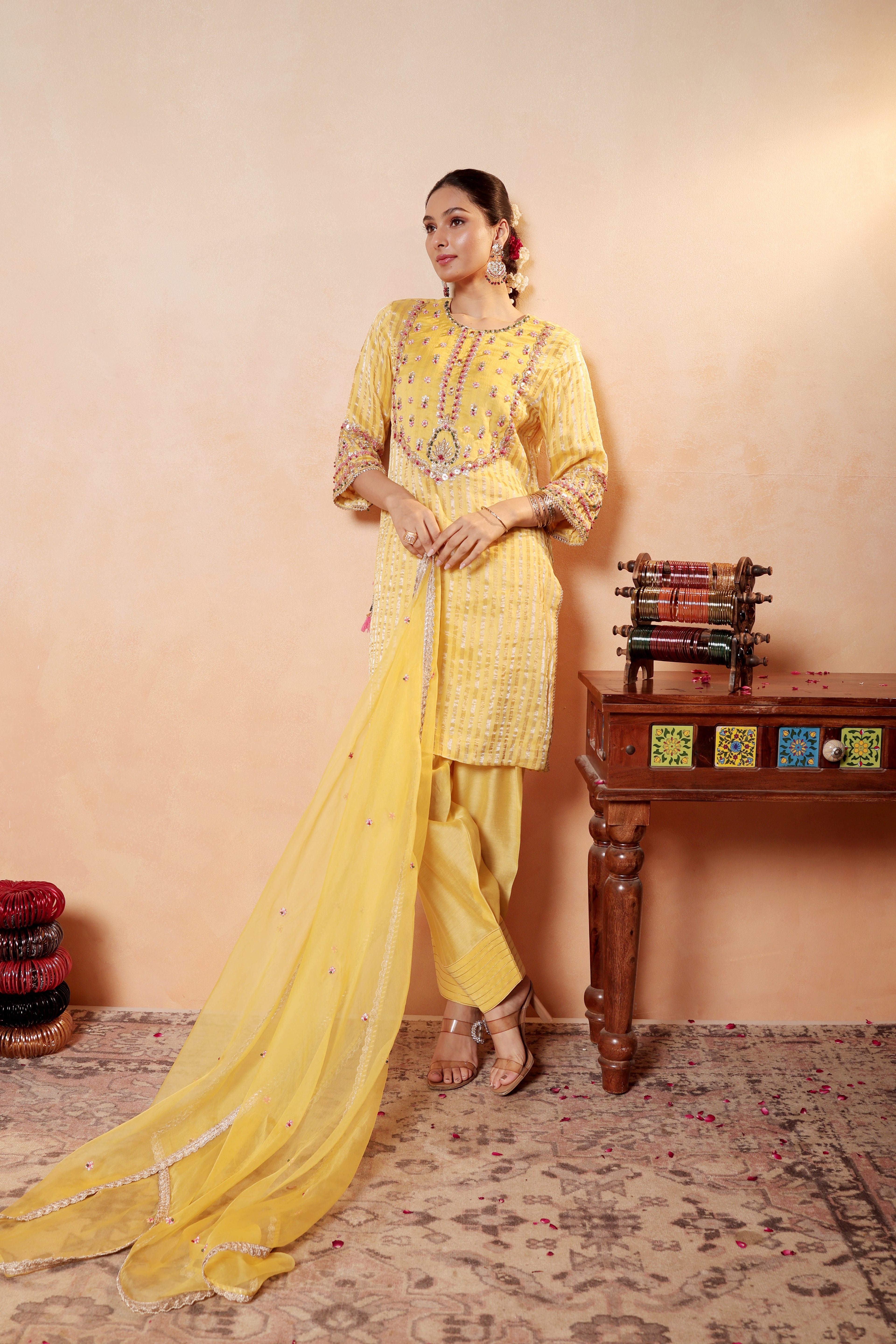 Model wearing yellow silk striper tissue kurta with intricate gota embroidery, paired with regal farshi salwar and dupatta – Sunehri Gota Collection by House of AAS.