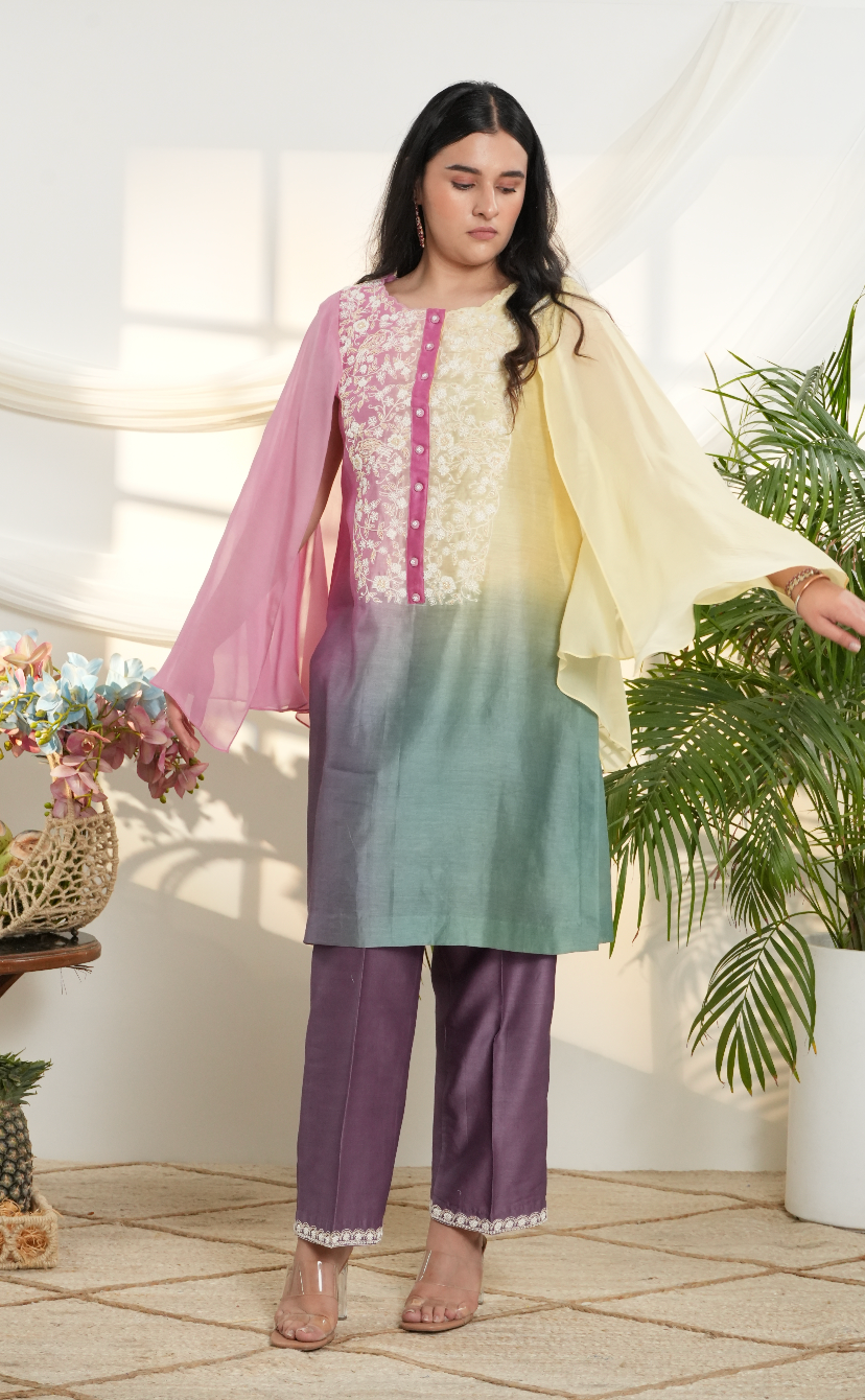 Model wearing a multicolor ombre silk chanderi kurta set in pastel yellow, pink & green with purple pants and off-white dori bead embroidery.