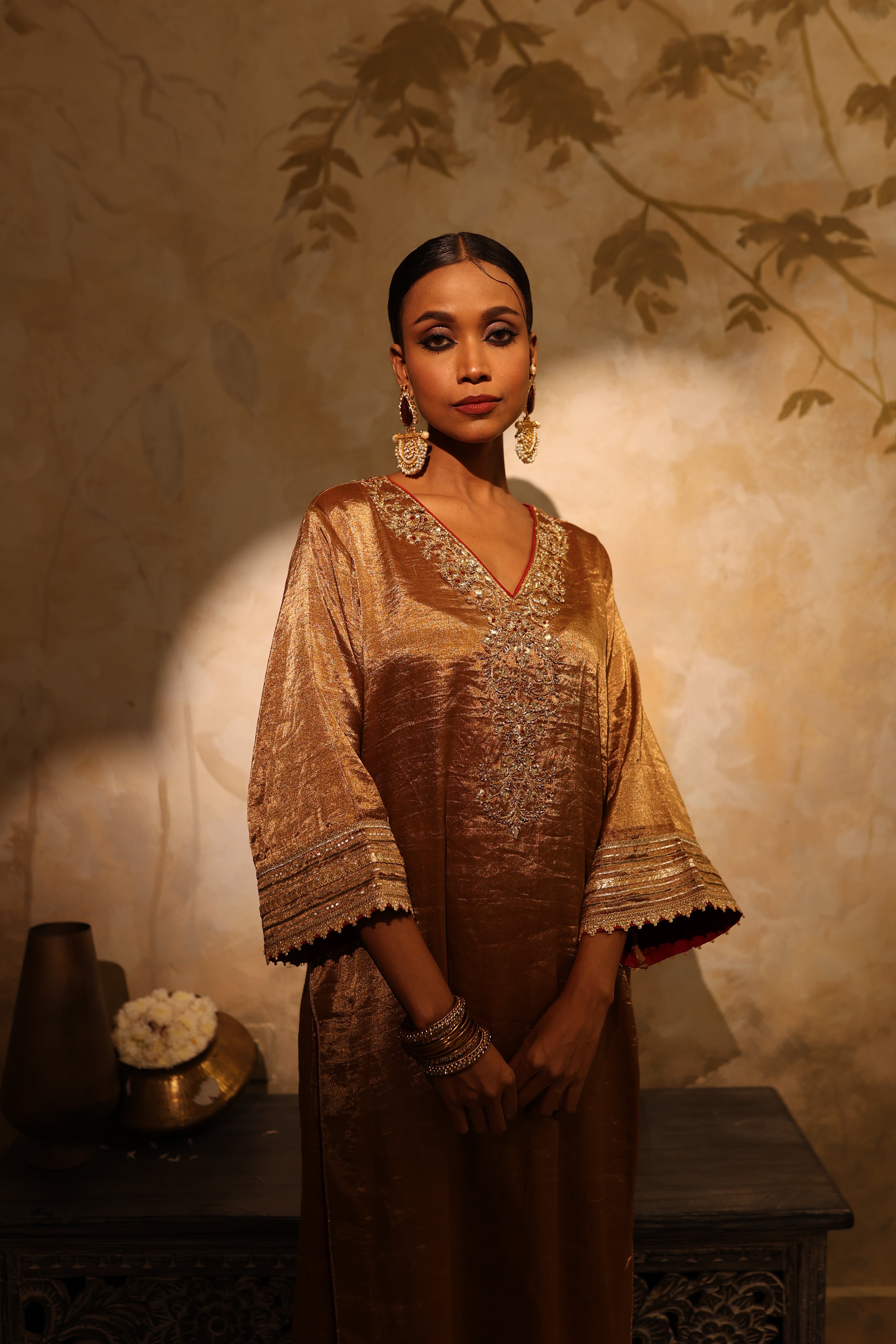 Antique gold silk tissue kurta set with intricate gota, resham, bead and dabka embroidery, paired with a red dupatta – festive women’s outfit