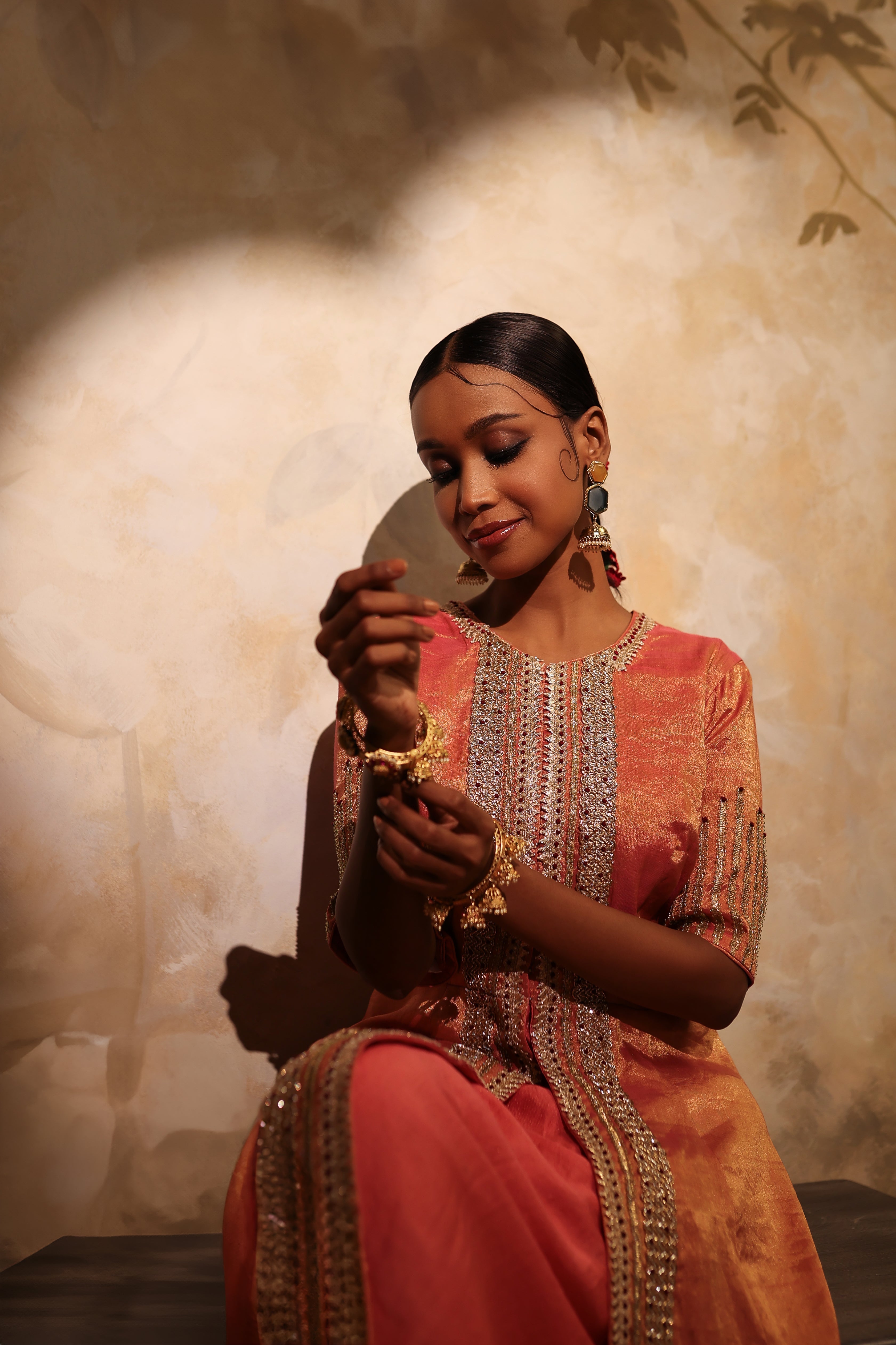 Luxury coral pink silk tissue kurta set with hand embroidery and matching pants.