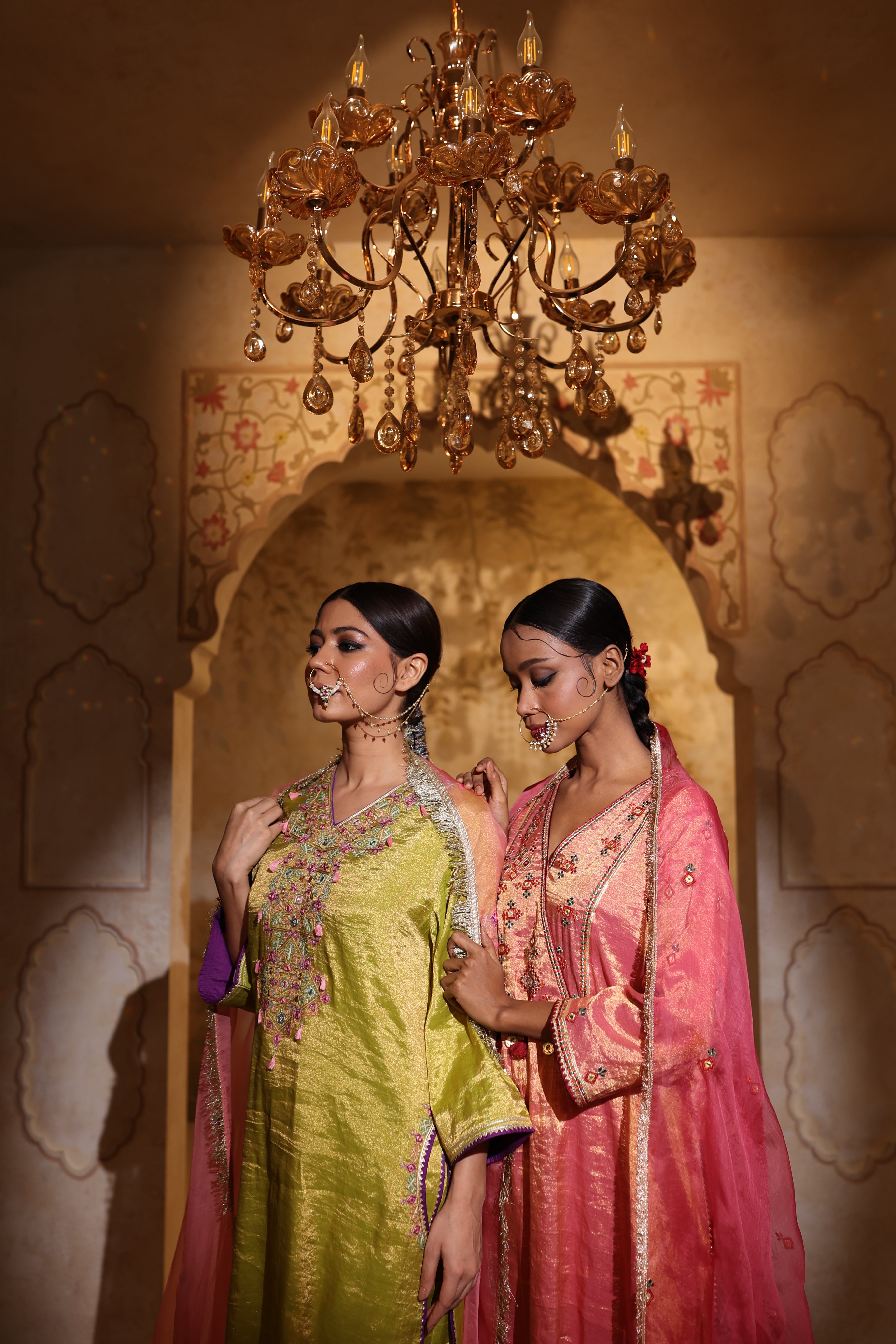 Woman in an embroidered green tisue kurta and pink organza dupatta traditional outfit perfect for festive wear or a trousseau from Shayari collection of House of AAS.