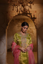 Woman in an embroidered green tisue kurta and pink organza dupatta traditional outfit perfect for festive wear or a trousseau from Shayari collection of House of AAS.