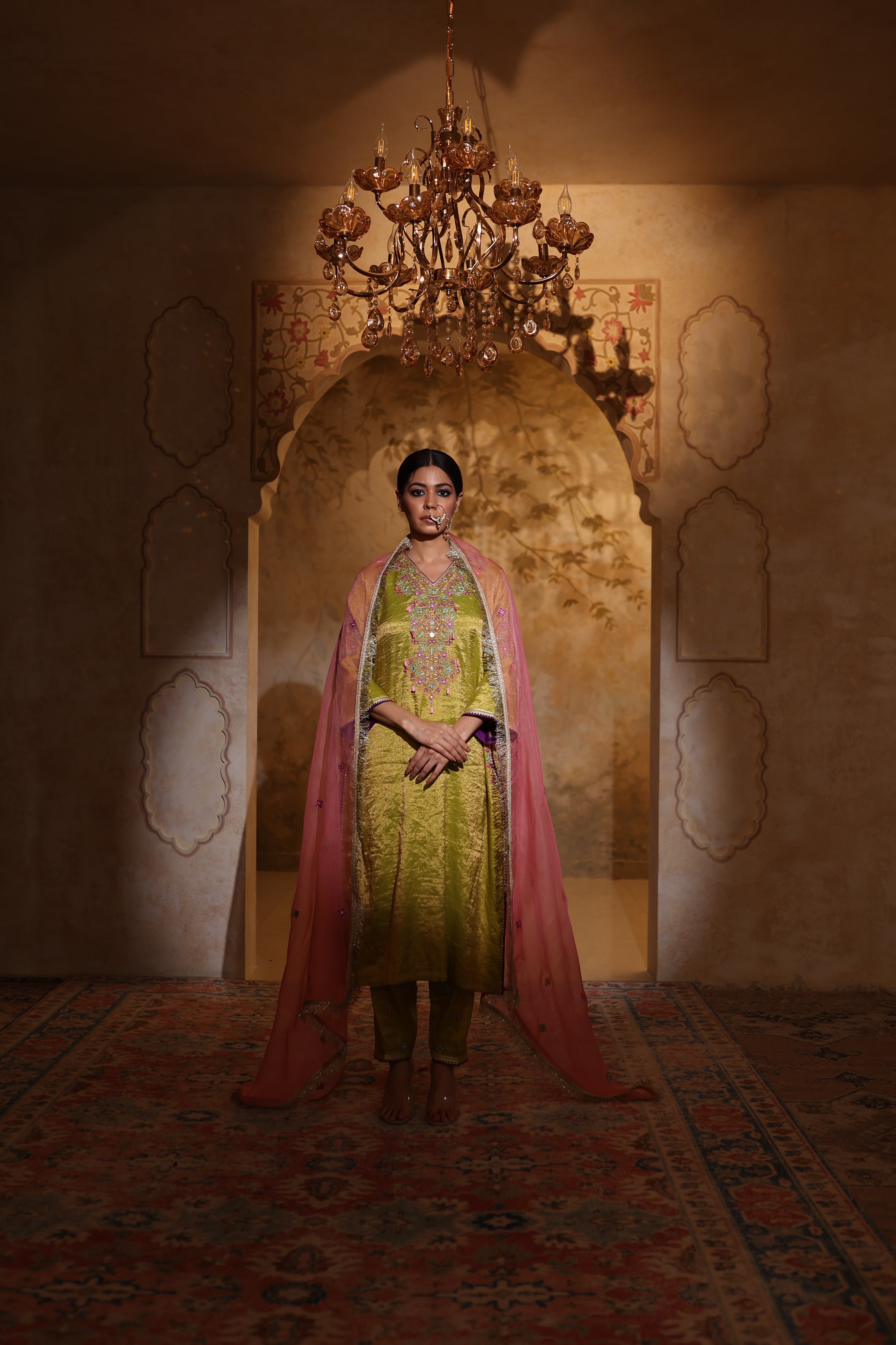 Woman in an embroidered green tisue kurta and pink organza dupatta traditional outfit perfect for festive wear or a trousseau from Shayari collection of House of AAS.