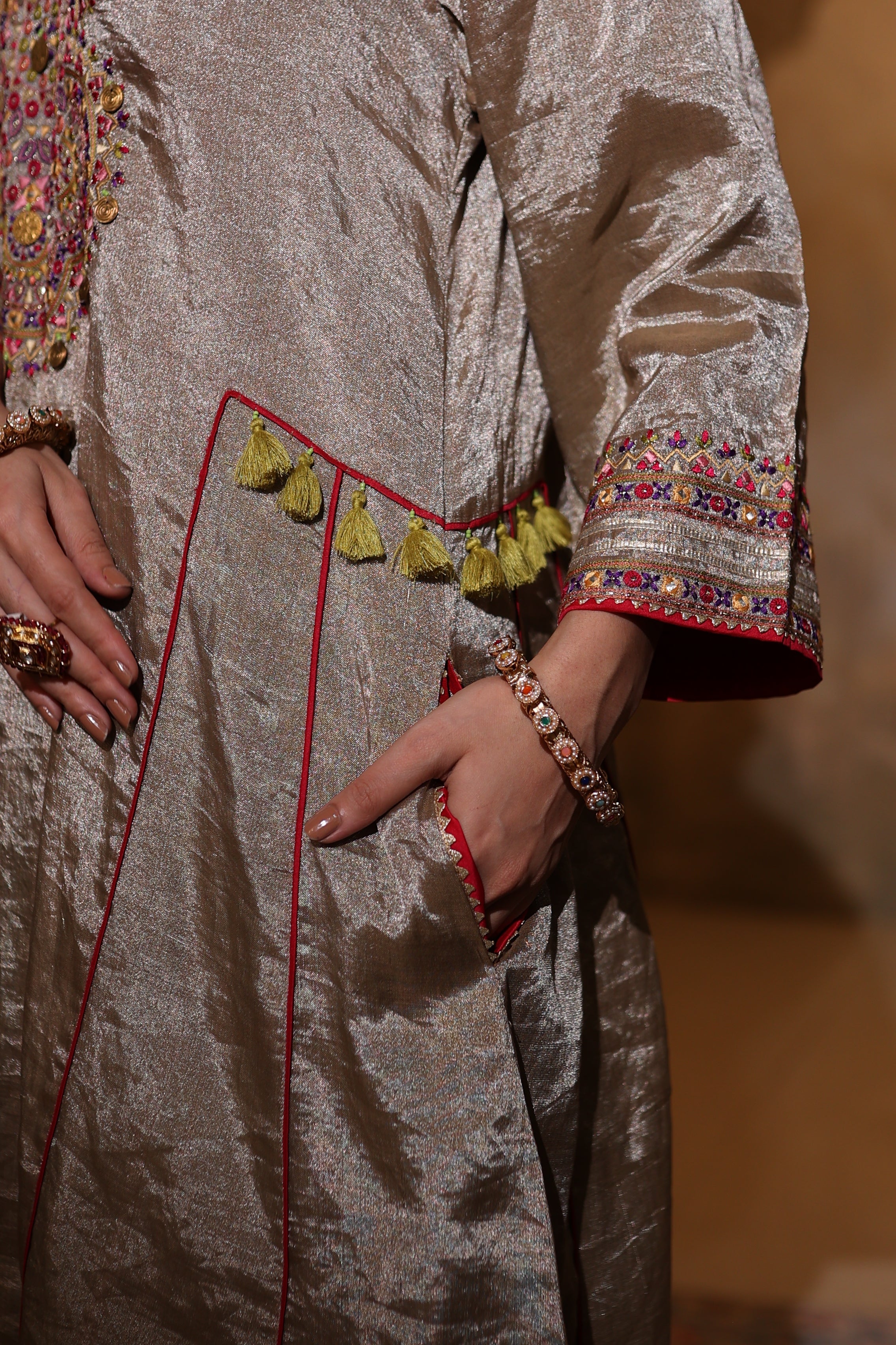 Close-up of hand-embroidered antique silver kurta in tissue fabric