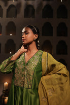 Model wearing a green silk chanderi kurta set with mustard dupatta and zari hand embroidery — festive and wedding outfit.