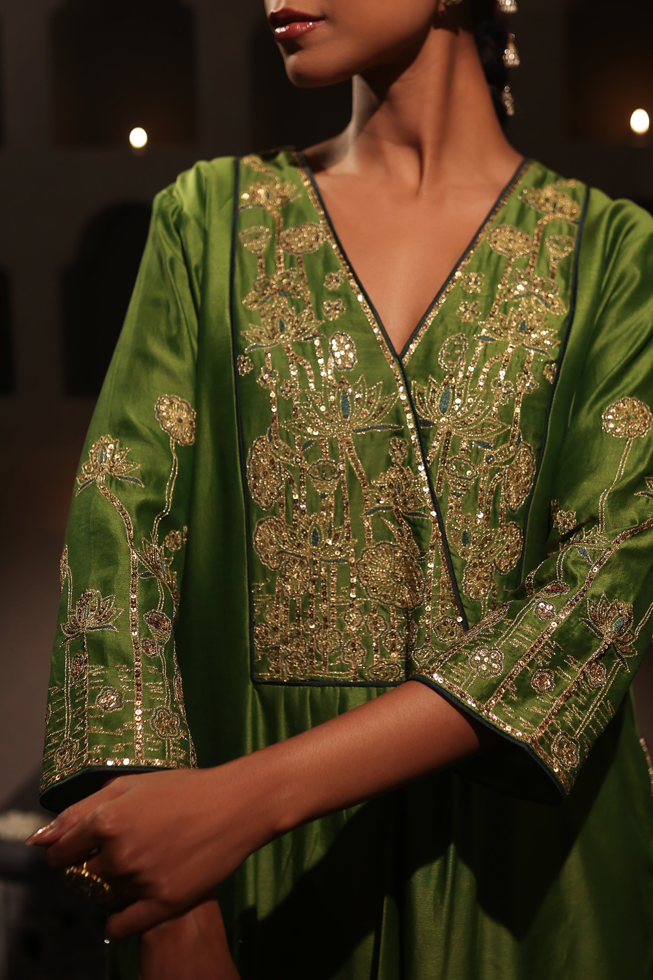 Model wearing a green silk chanderi kurta set with mustard dupatta and zari aari  hand embroidery — festive and wedding outfit.