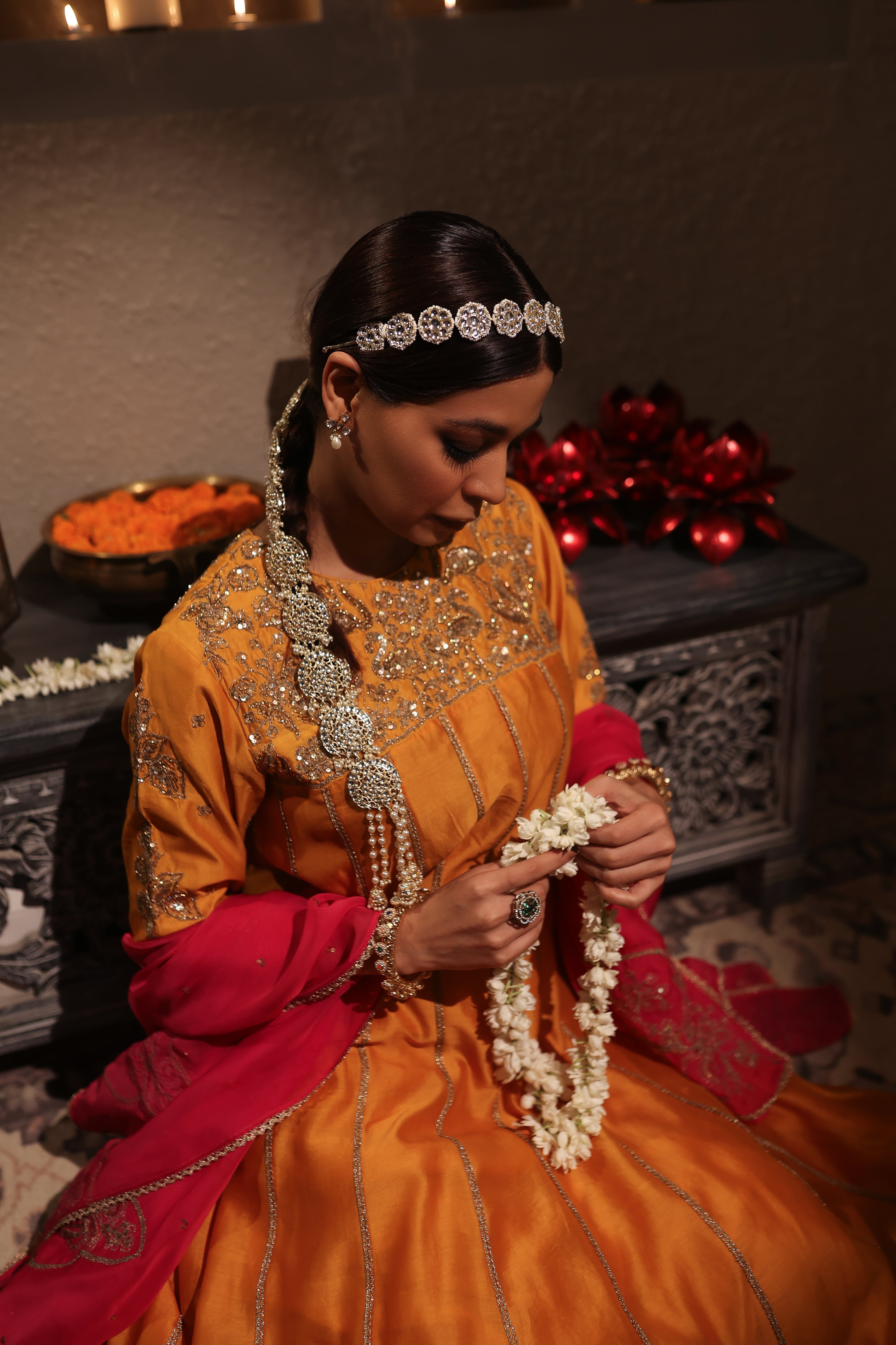 Model wearing an orange silk chanderi kurta set with pink dupatta, adorned with gold zari hand embroidery — festive wedding outfit.