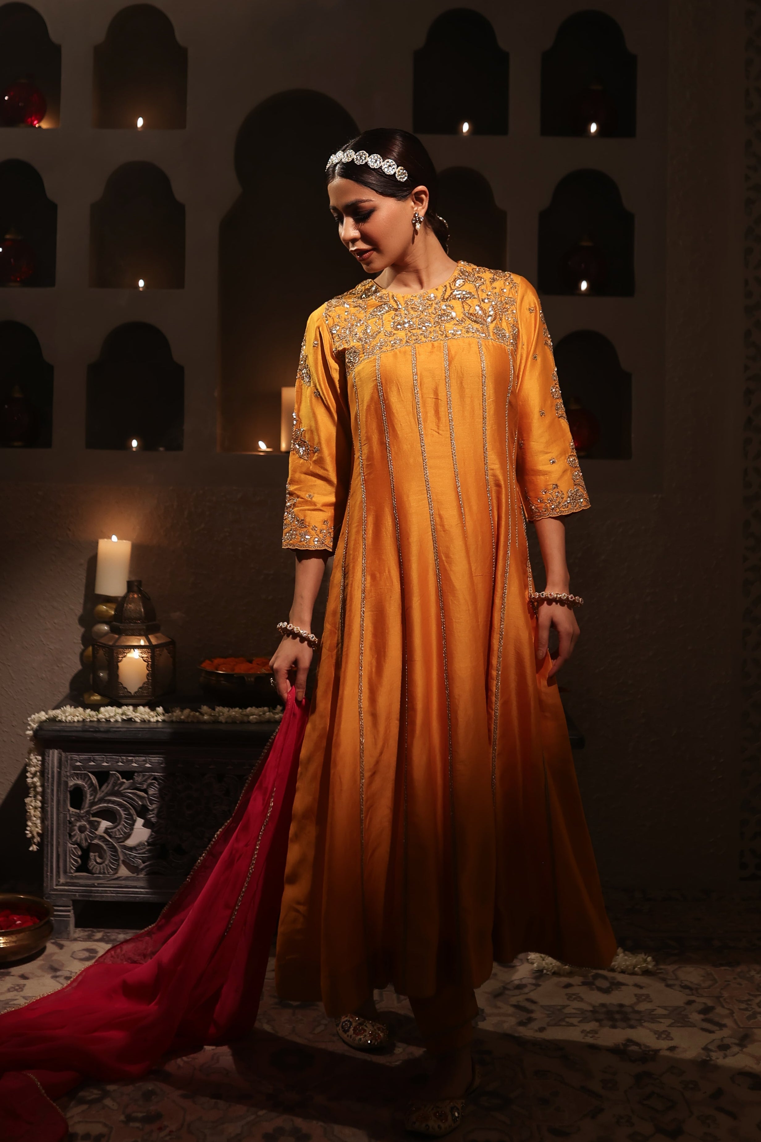 Model wearing an orange silk chanderi kurta set with pink dupatta, adorned with gold zari hand embroidery — festive wedding outfit.