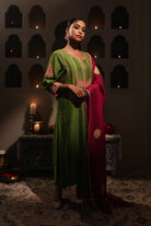 Model wearing a green silk chanderi kurta set with pink dupatta, featuring gold zari aari taari hand embroidery — festive ethnic outfit.
