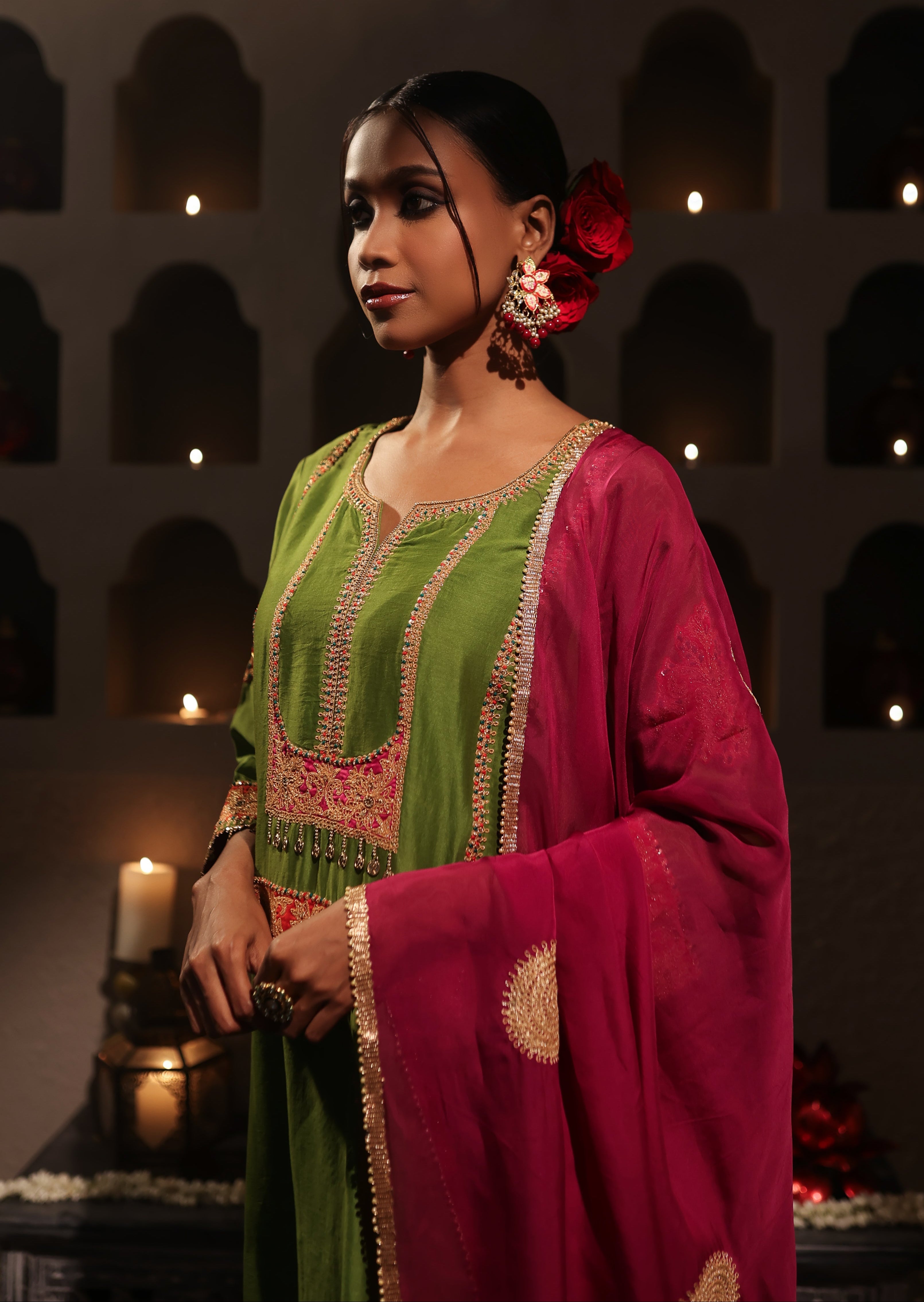 Model wearing a green silk chanderi kurta set with pink dupatta, featuring gold zari aari taari hand embroidery — festive ethnic outfit.
