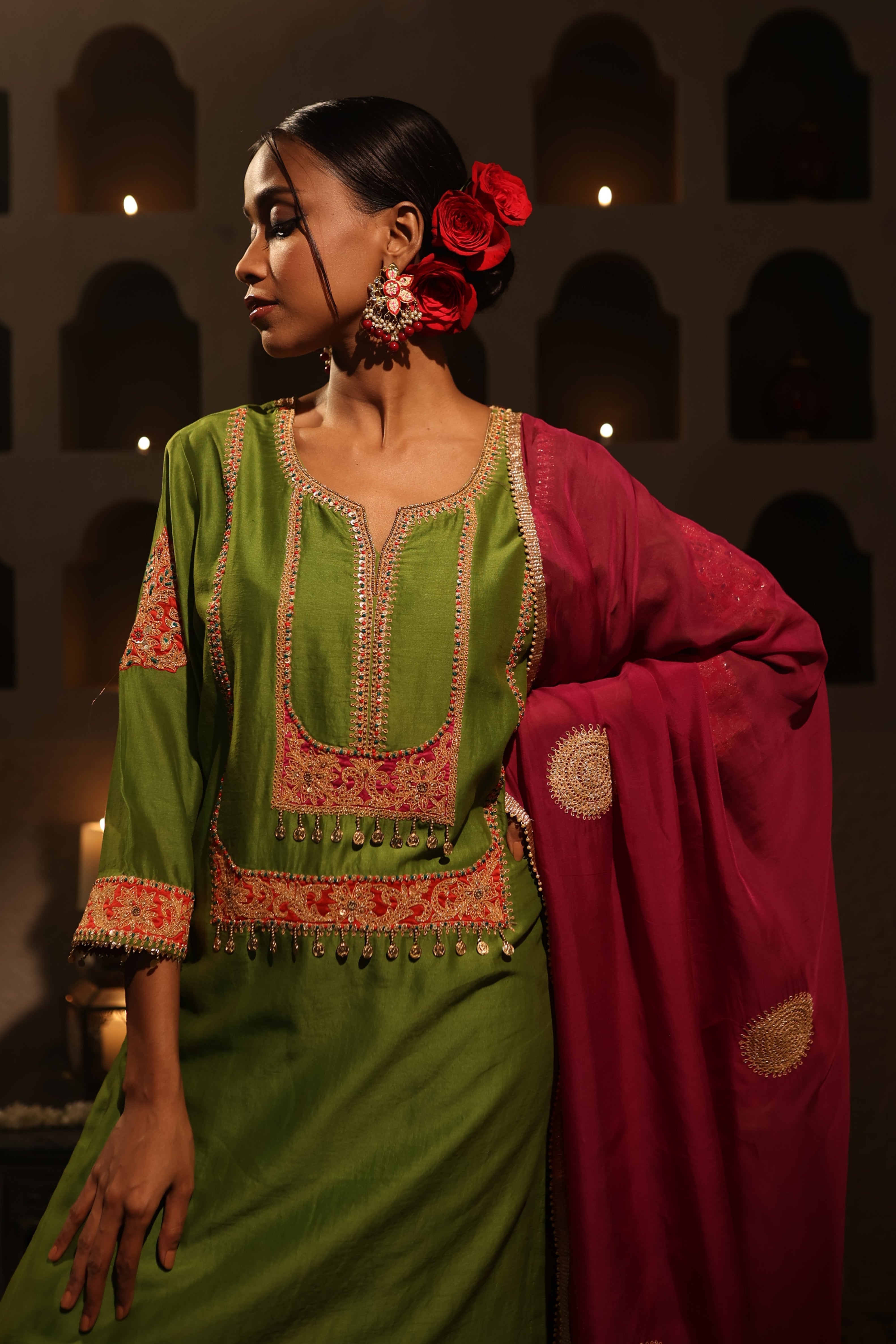 Model wearing a green silk chanderi kurta set with pink dupatta, featuring gold zari aari taari hand embroidery — festive ethnic outfit.