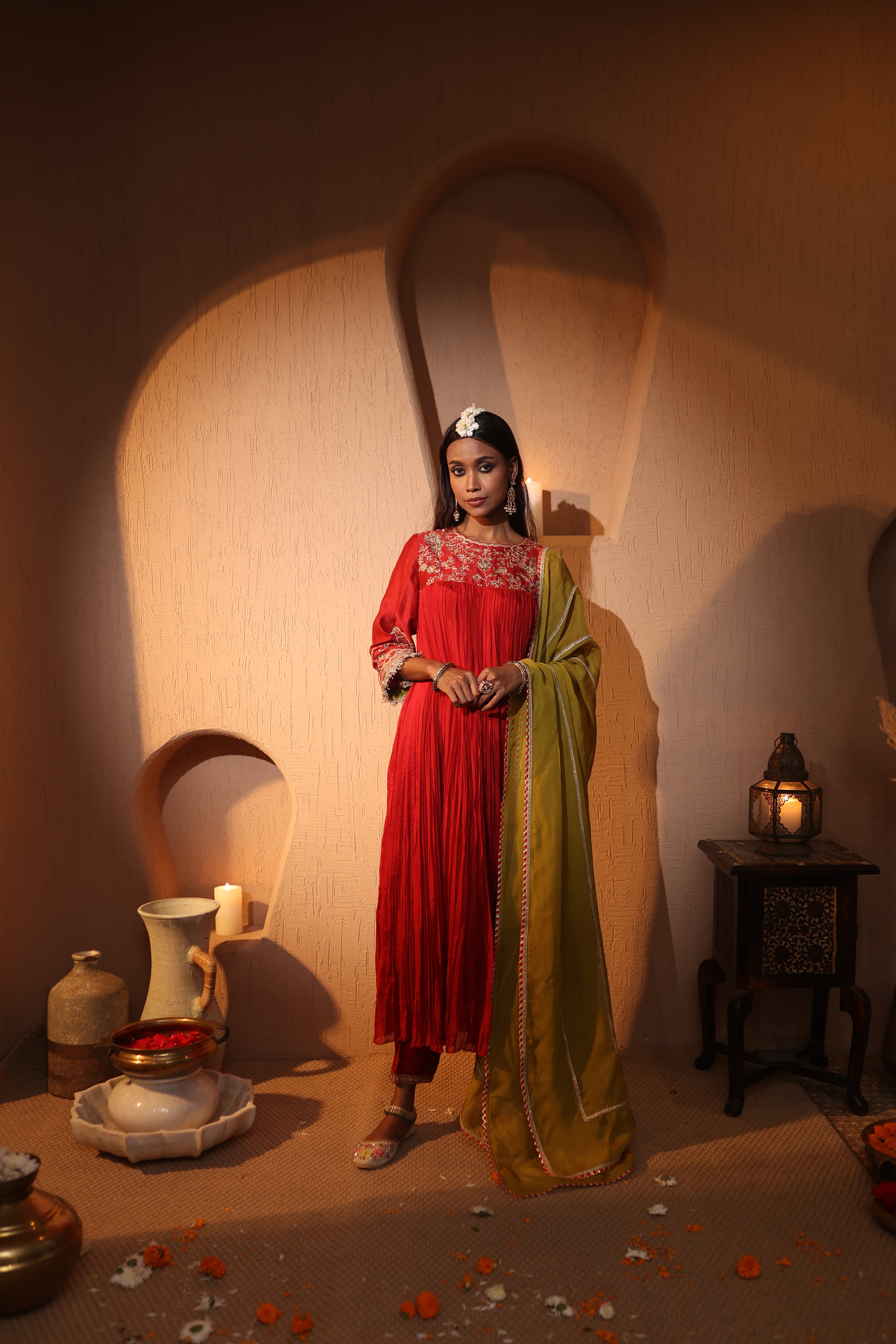 Model wearing a red silk chanderi kurta set with aari taari zari hand embroidery, styled with an olive green dupatta — festive ethnic outfit for weddings and celebrations.