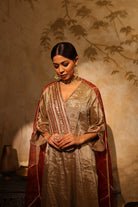 Antique silver silk tissue kurta set with intricate gota, sequin, dabka and resham embroidery, paired with dupatta – timeless festive outfit.