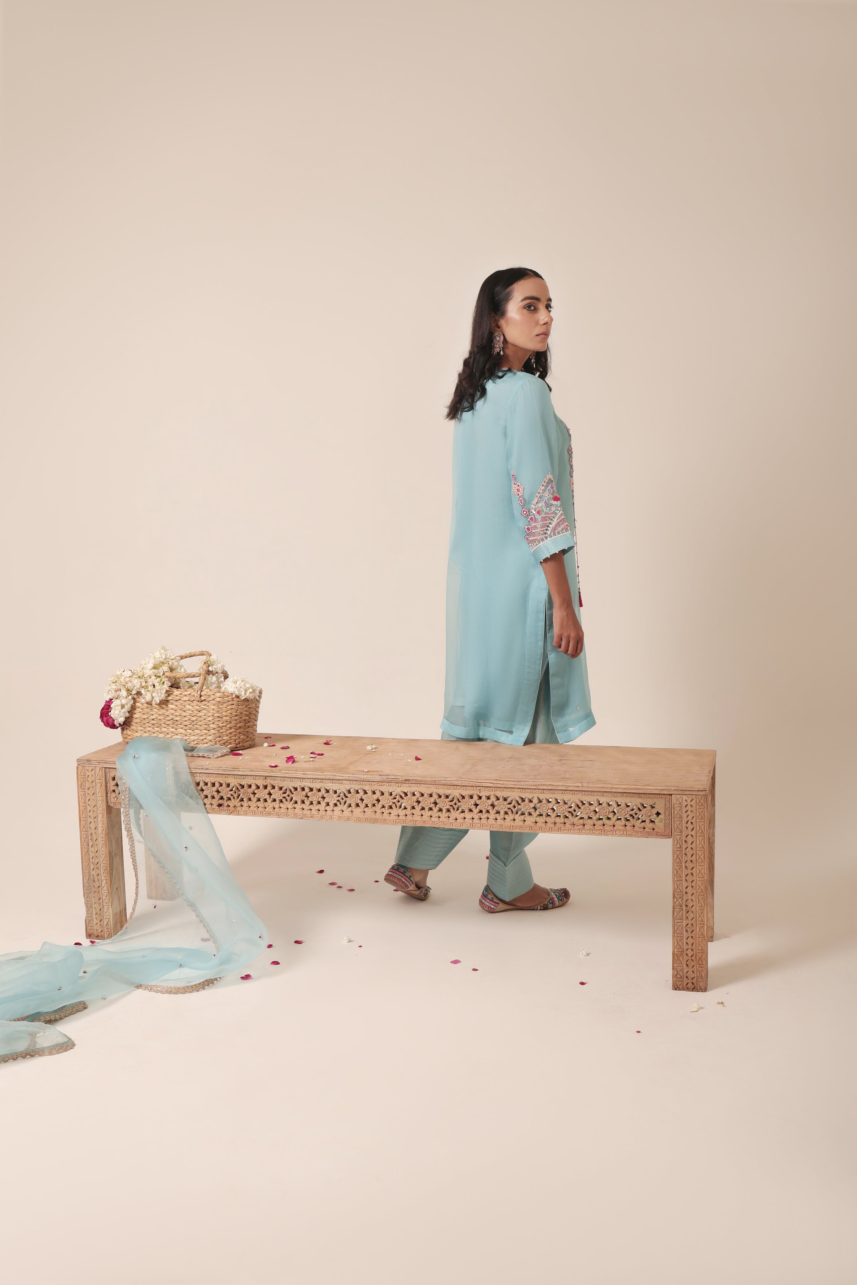 odel wearing sky blue tissue kurta with intricate mirror embroidery, paired with traditional farshi salwar and dupatta – Jhilmil Collection by House of AAS.