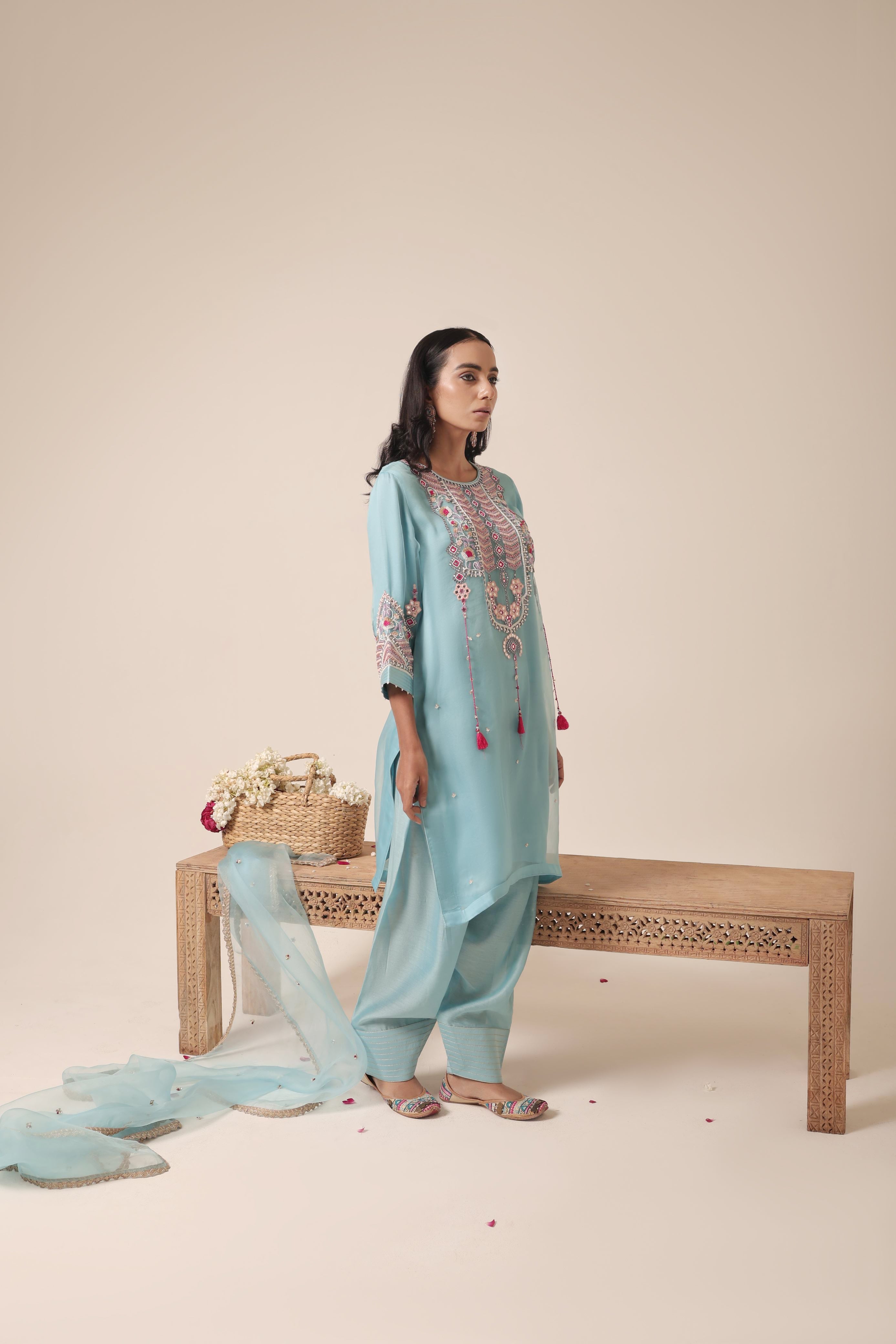 odel wearing sky blue tissue kurta with intricate mirror embroidery, paired with traditional farshi salwar and dupatta – Jhilmil Collection by House of AAS.