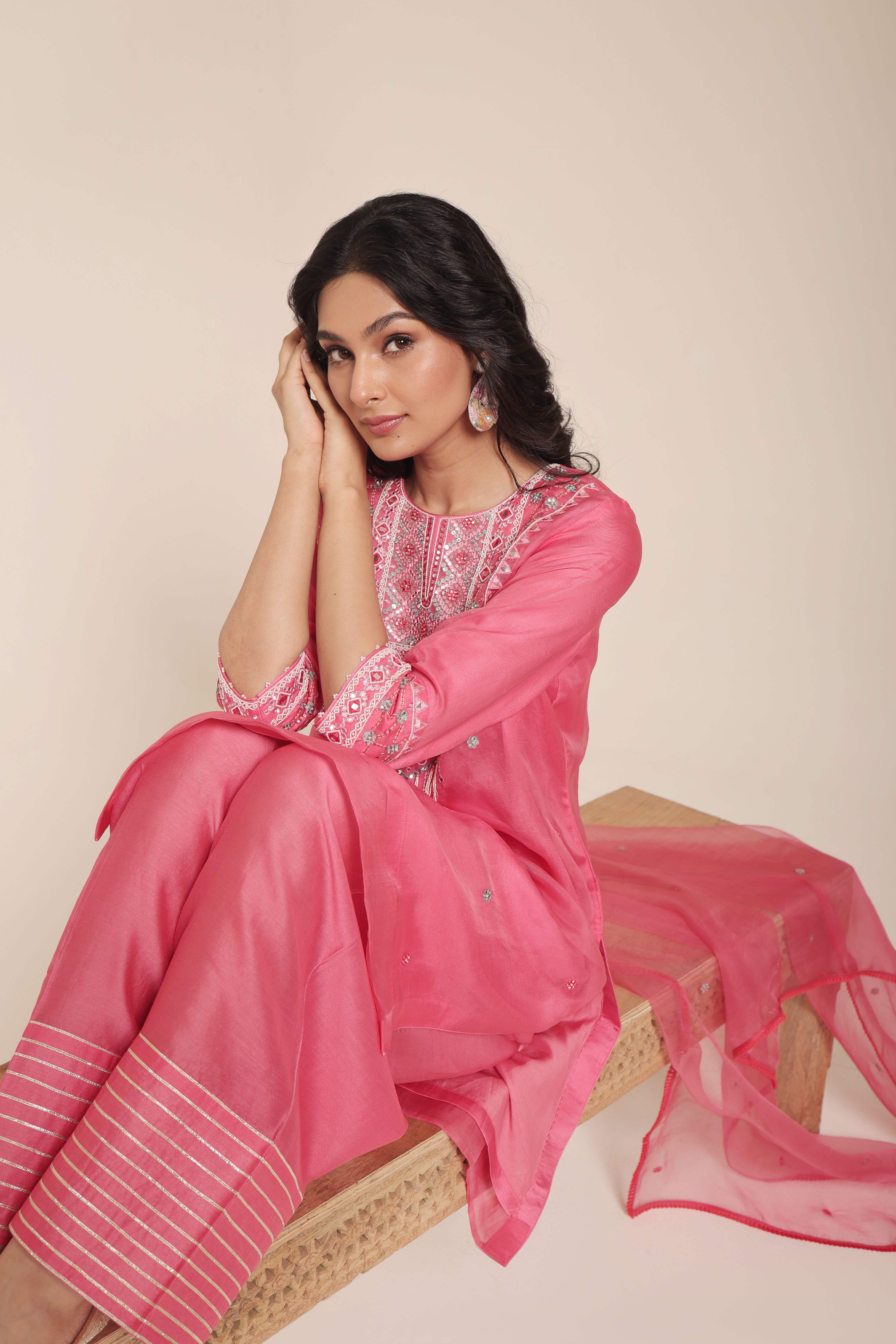 Model wearing pink tissue kurta with intricate mirror embroidery, styled with regal farshi salwar and dupatta – Jhilmil Collection by House of AAS.