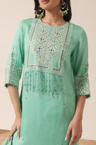 Close-up of mirror embroidery on mint green organza kurta with tassel details – Jhilmil Collection by House of AAS.