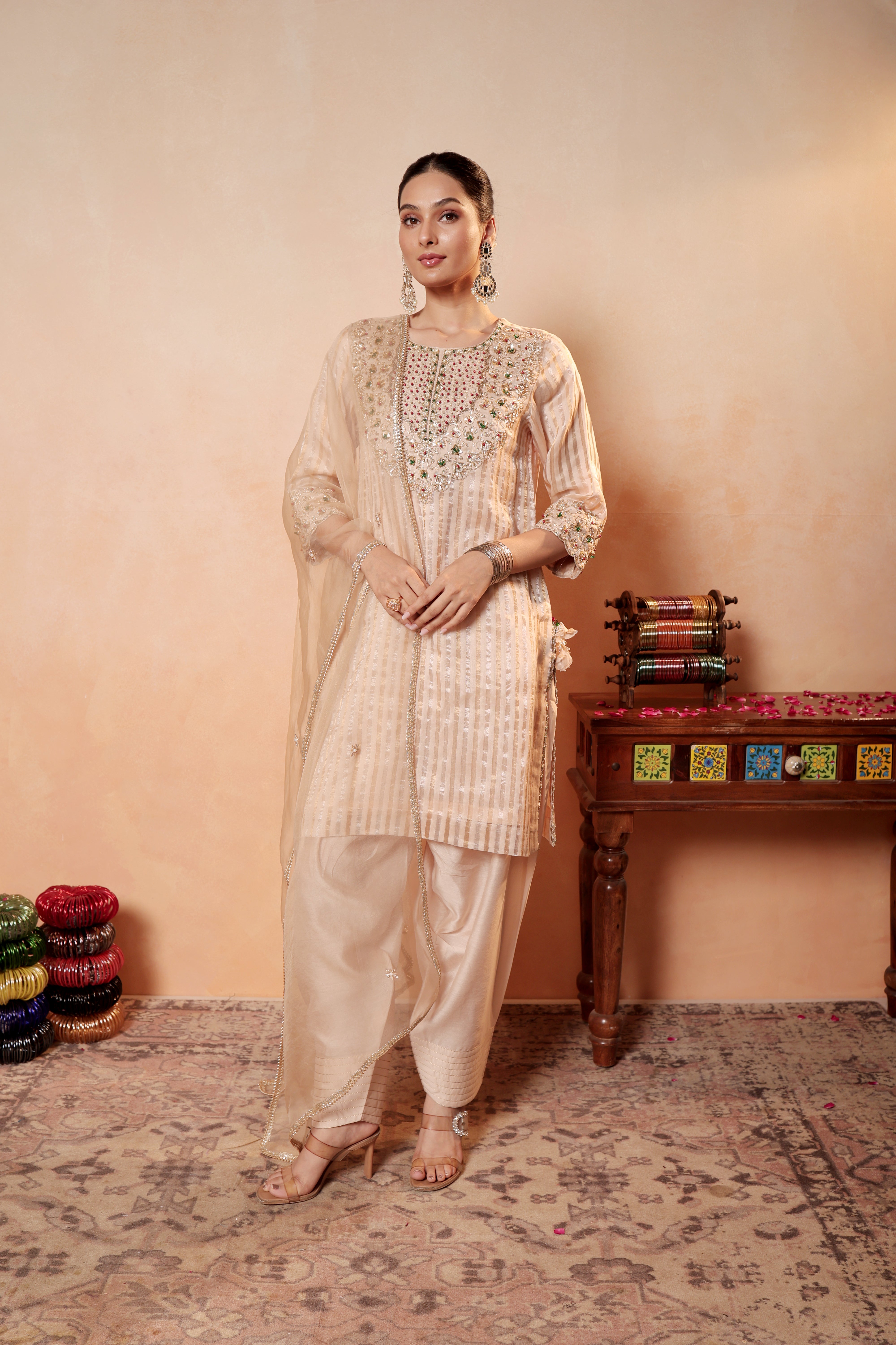 Model wearing beige Tissue Silk Chanderi kurta set from Sunehri Gota Collection with hand embroidery, farshi salwar, and dupatta – festive and wedding wear.