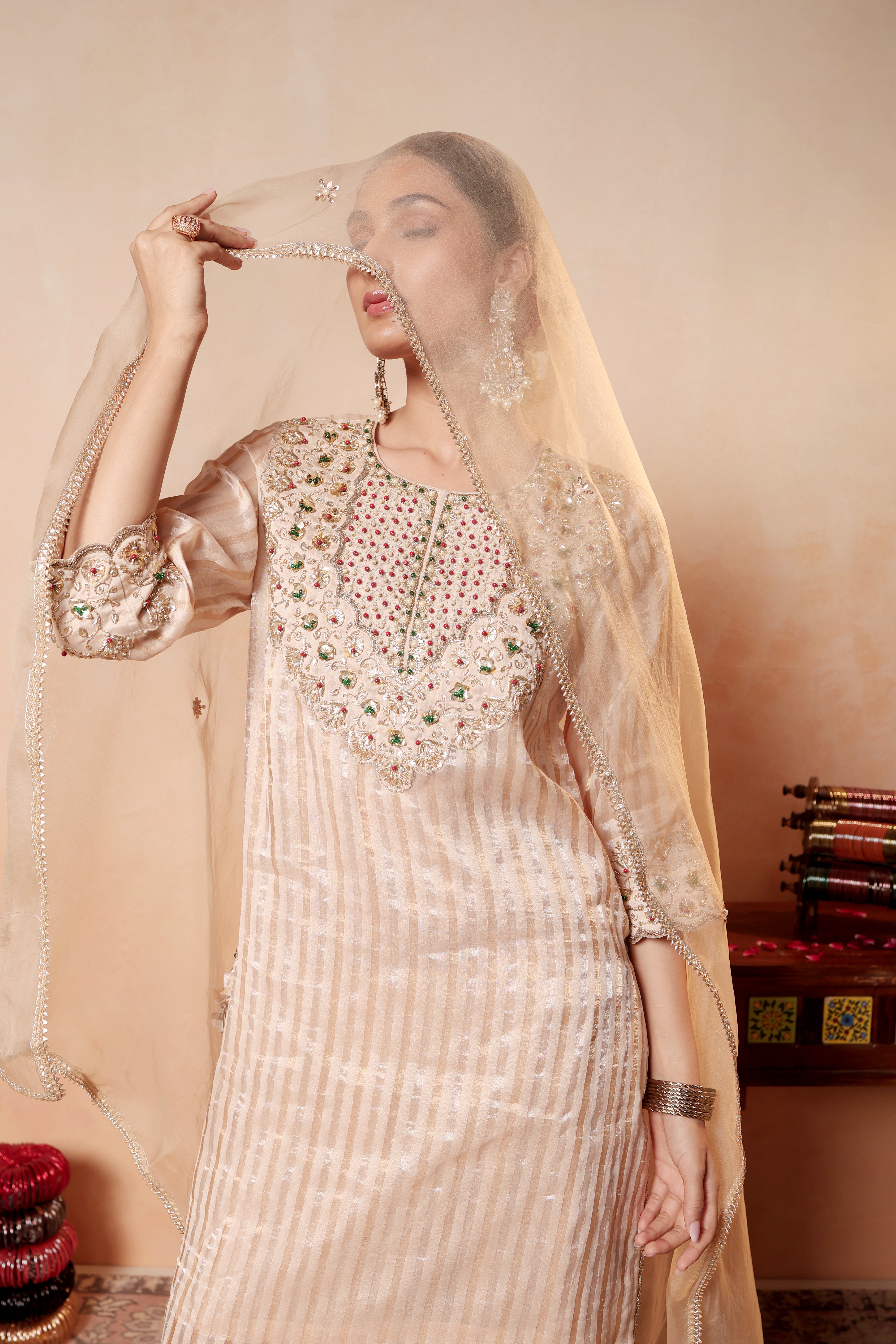 Model wearing beige Tissue Silk Chanderi kurta set from Sunehri Gota Collection with hand embroidery, farshi salwar, and dupatta – festive and wedding wear.