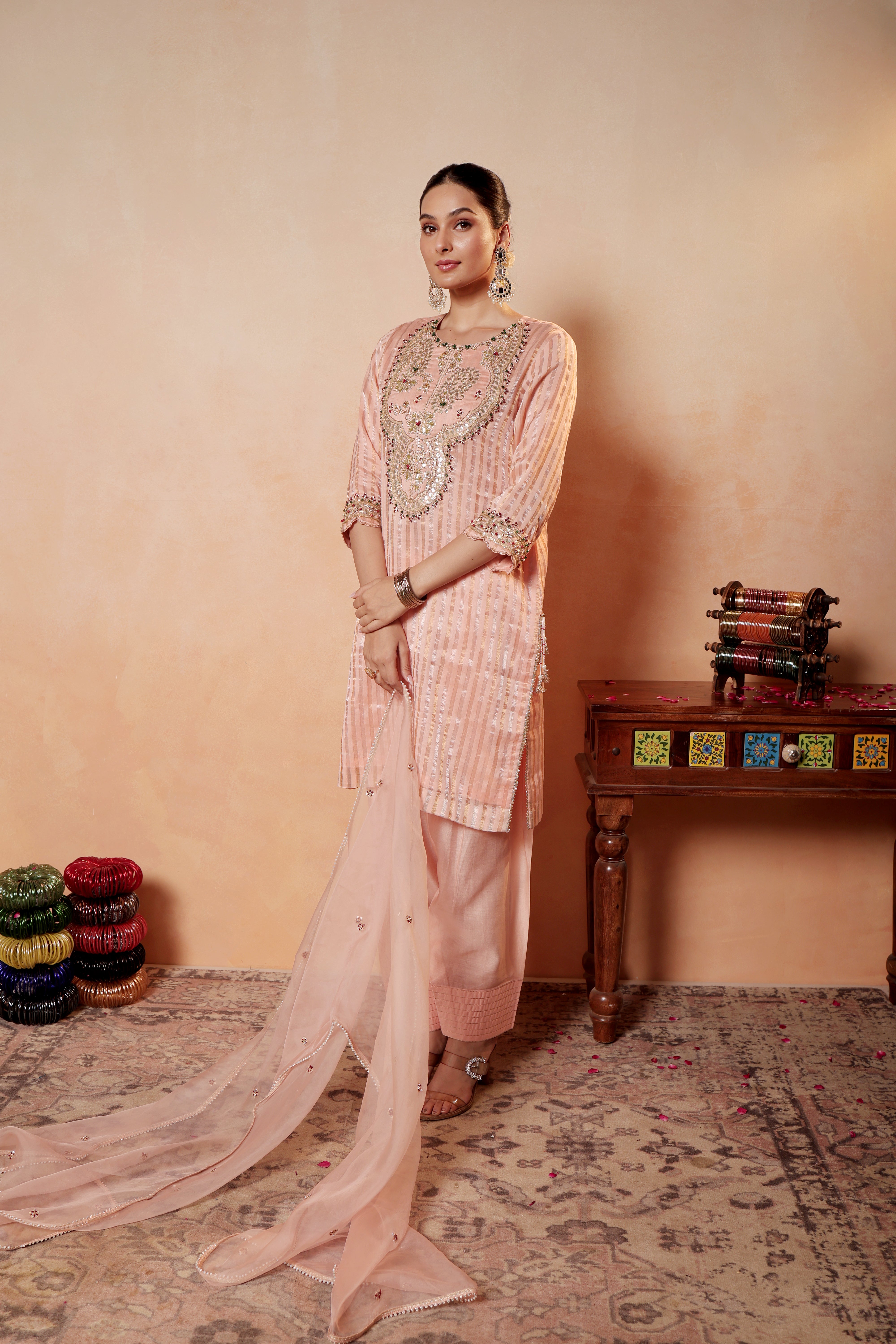 Model wearing peach Tissue Silk Chanderi kurta with gota embroidery, paired with regal farshi salwar and dupatta – Sunehri Gota Collection by House of AAS.