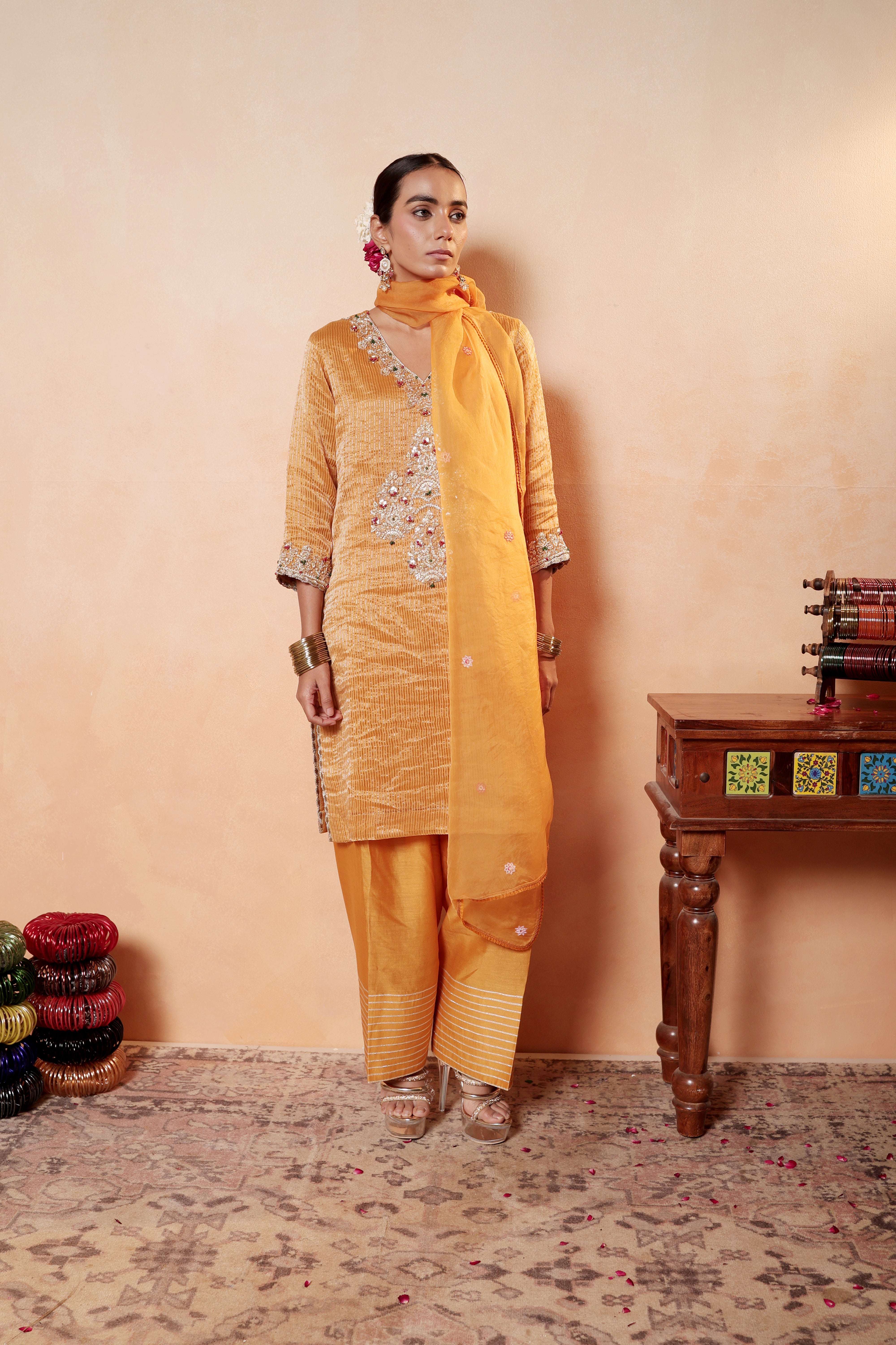 Model wearing orange silk striper tissue kurta with gota embroidery, paired with regal farshi salwar and dupatta – Sunehri Gota Collection by House of AAS.