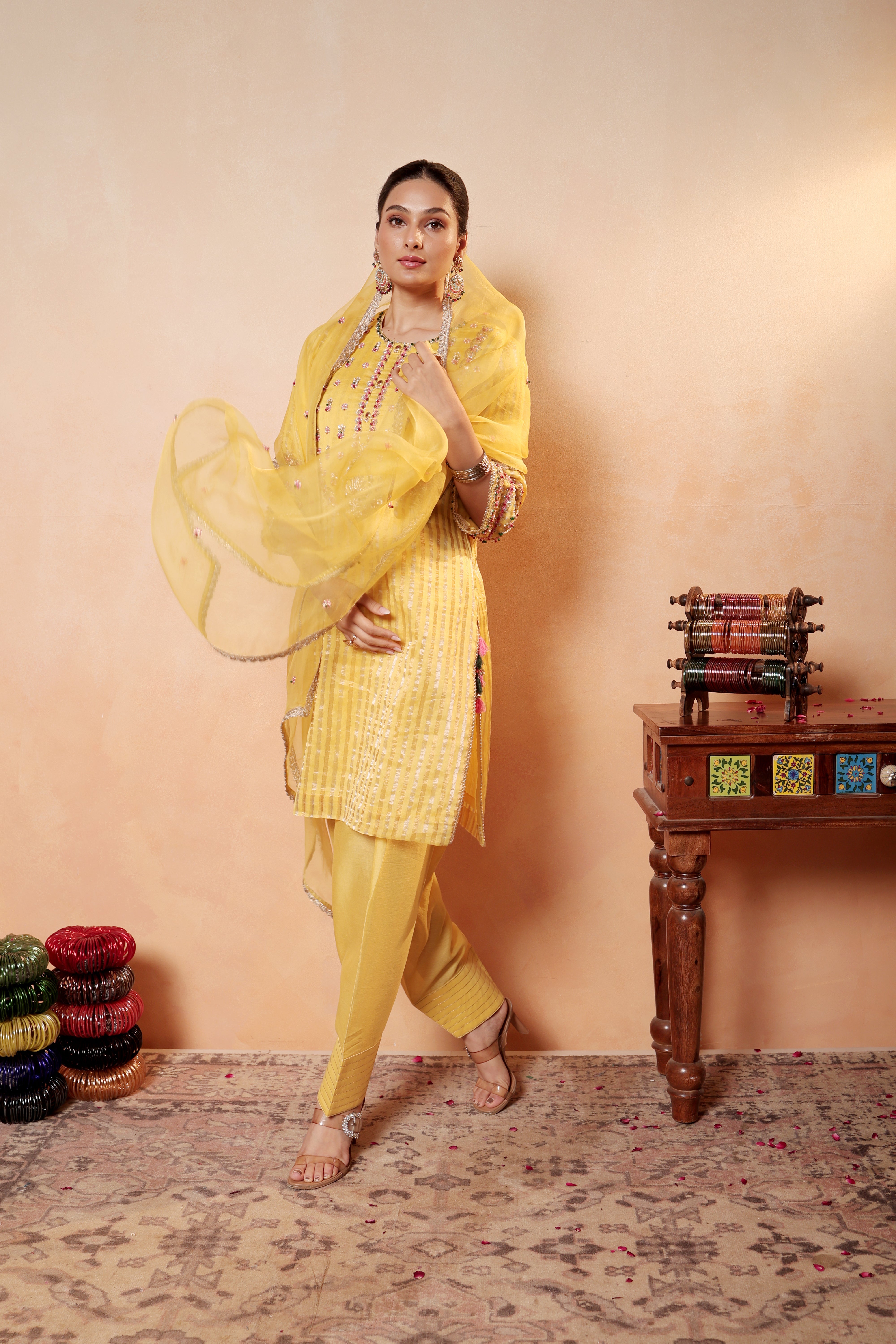 Model wearing yellow silk striper tissue kurta with intricate gota embroidery, paired with regal farshi salwar and dupatta – Sunehri Gota Collection by House of AAS.