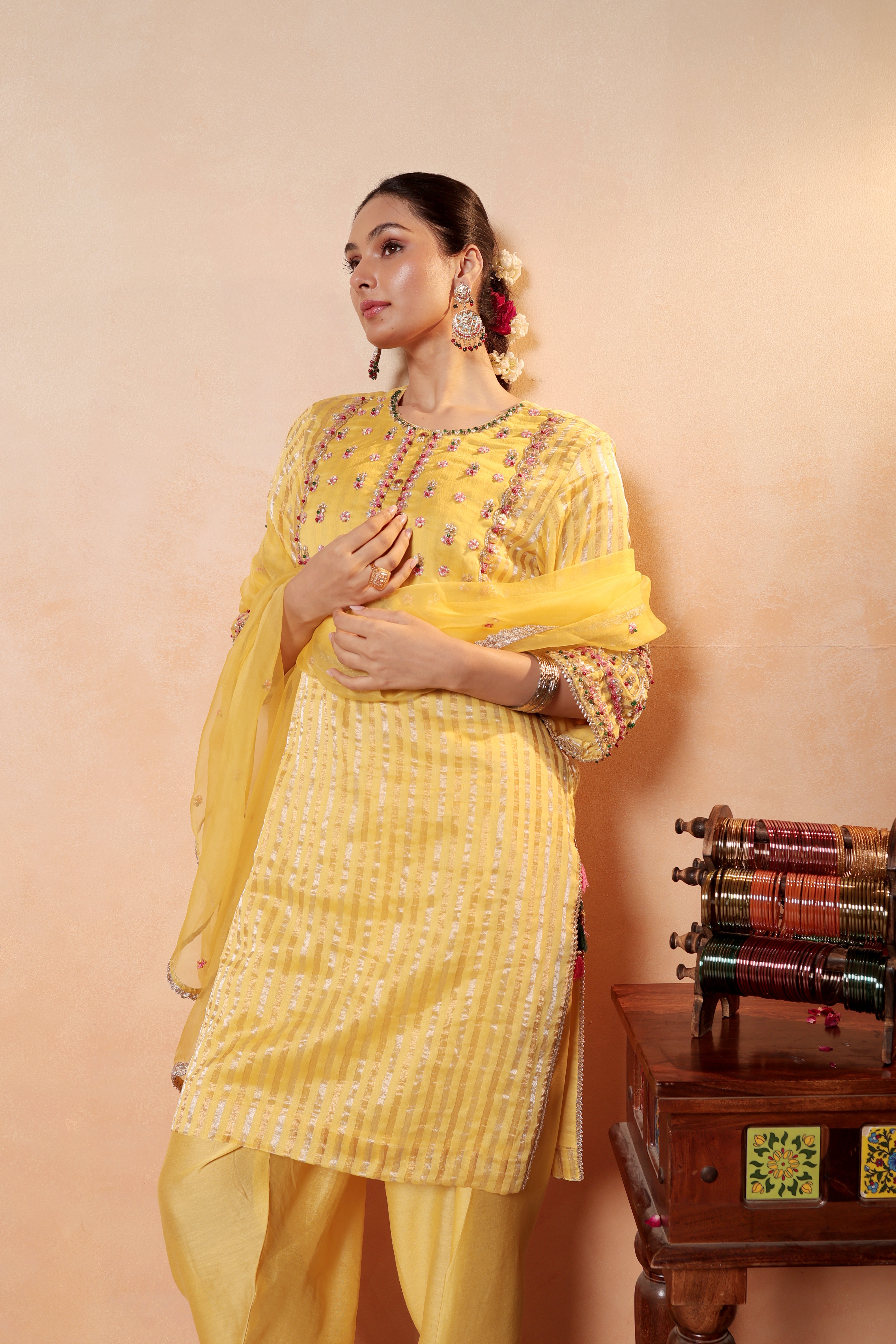 Model wearing yellow silk striper tissue kurta with intricate gota embroidery, paired with regal farshi salwar and dupatta – Sunehri Gota Collection by House of AAS.