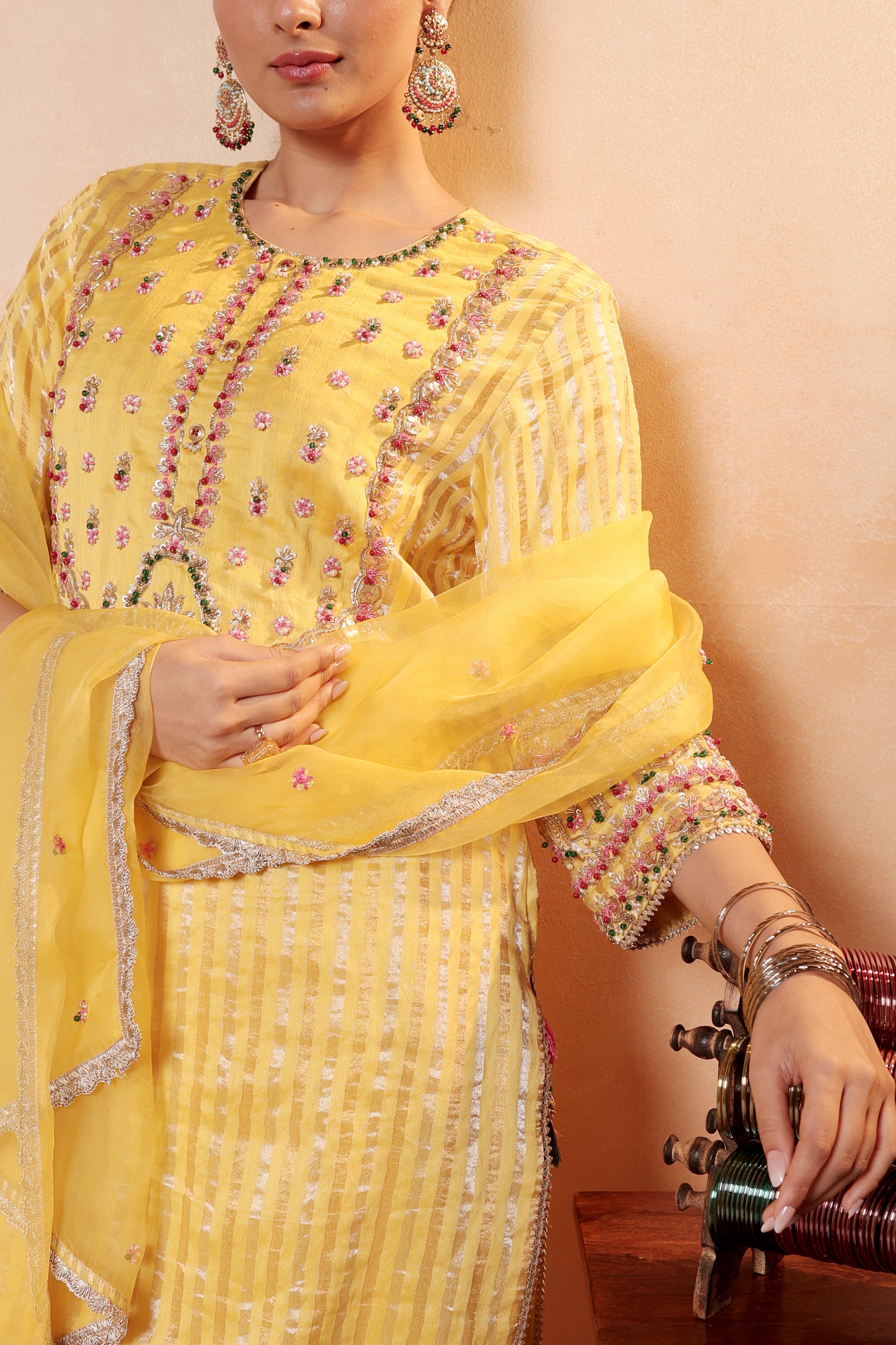 Model wearing yellow silk striper tissue kurta with intricate gota embroidery, paired with regal farshi salwar and dupatta – Sunehri Gota Collection by House of AAS.