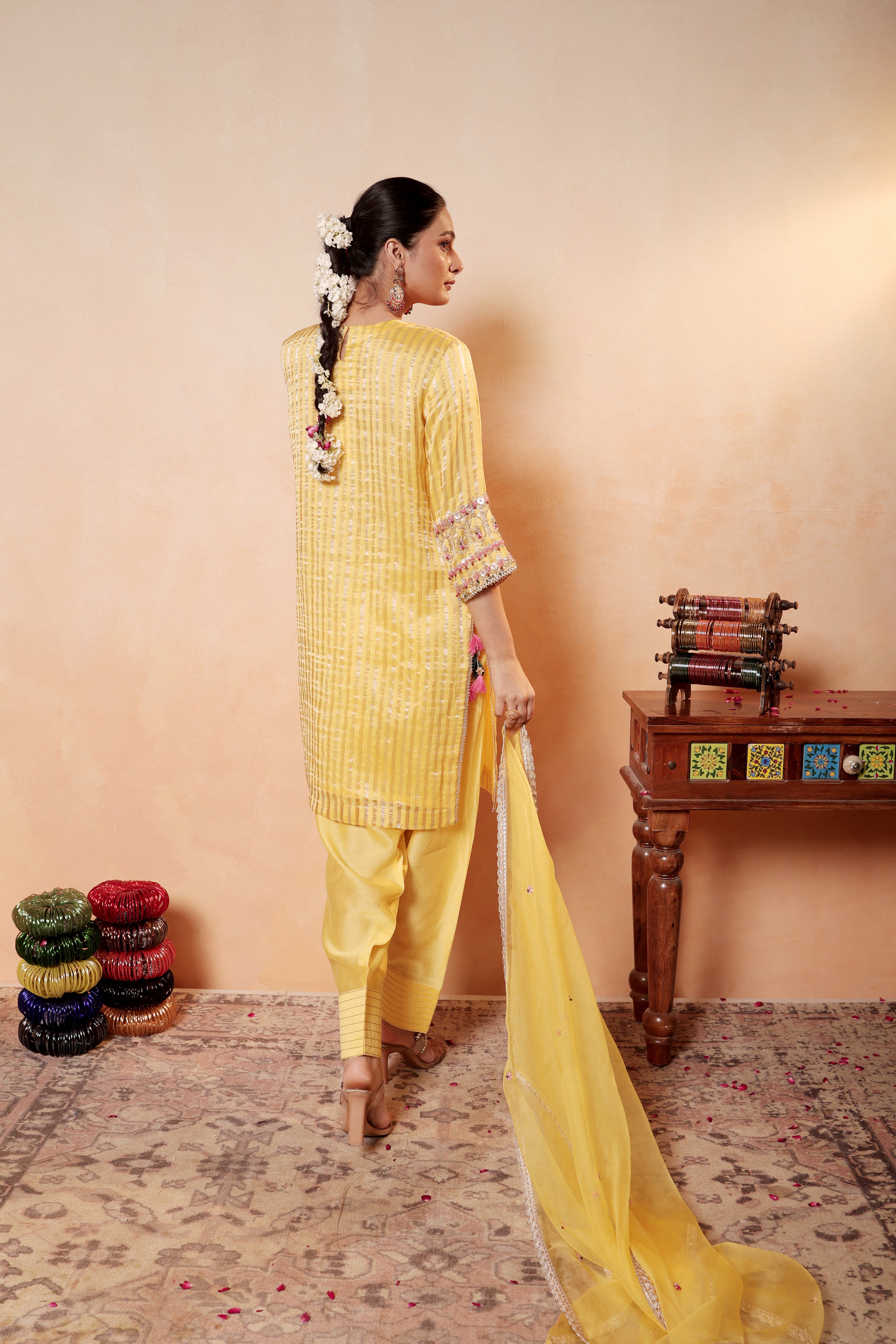 Model wearing yellow silk striper tissue kurta with intricate gota embroidery, paired with regal farshi salwar and dupatta – Sunehri Gota Collection by House of AAS.