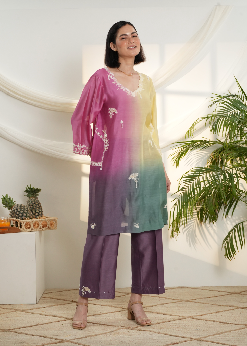 Model wearing a pink, yellow & green ombre silk chanderi kurta set with purple pants and off-white dori bead embroidery — festive ethnic outfit.