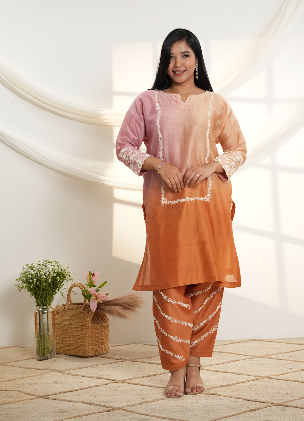 Model wearing a peach & rust ombre silk chanderi kurta set with off-white dori and bead embroidery, styled with striped embroidered salwar.