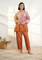 Model wearing a peach & rust ombre silk chanderi co-ord set with off-white dori and bead embroidery, styled with scalloped hem pants — festive outfit.