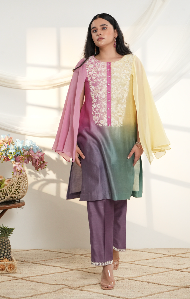 Model wearing a multicolor ombre silk chanderi kurta set in pastel yellow, pink & green with purple pants and off-white dori bead embroidery.